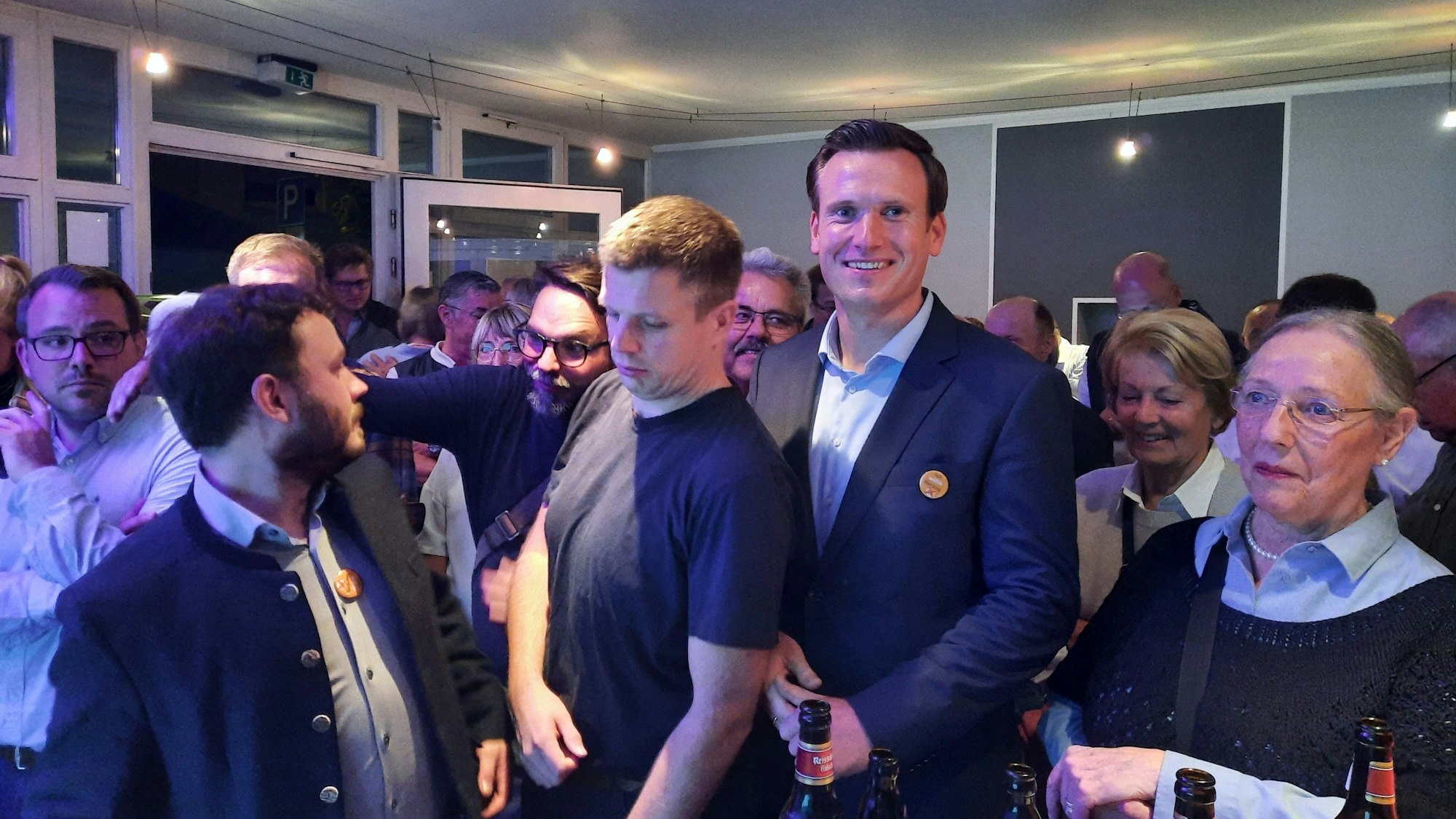 Viele Menschen drängen sich in einem Raum.