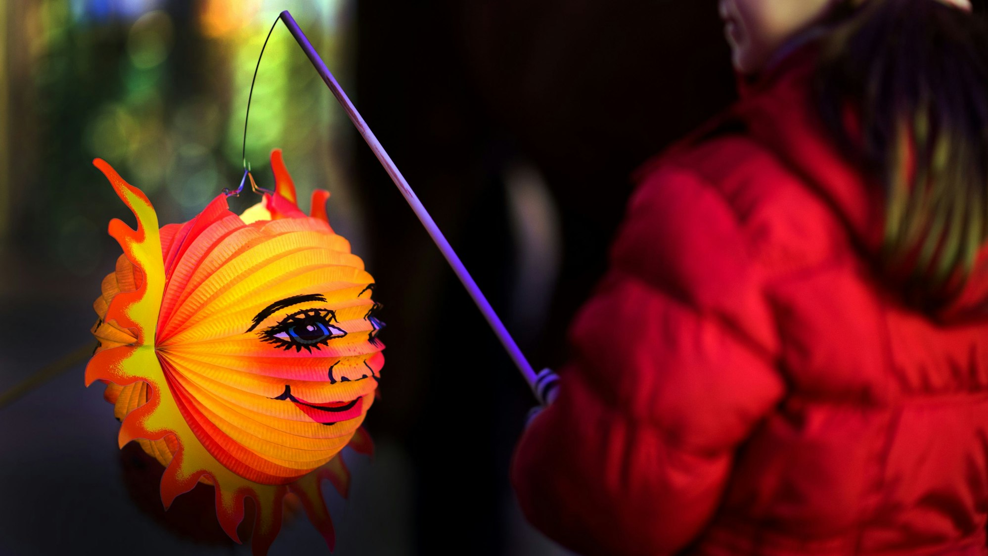 Eine beleuchtete Laterne in der Hand eines Kindes.