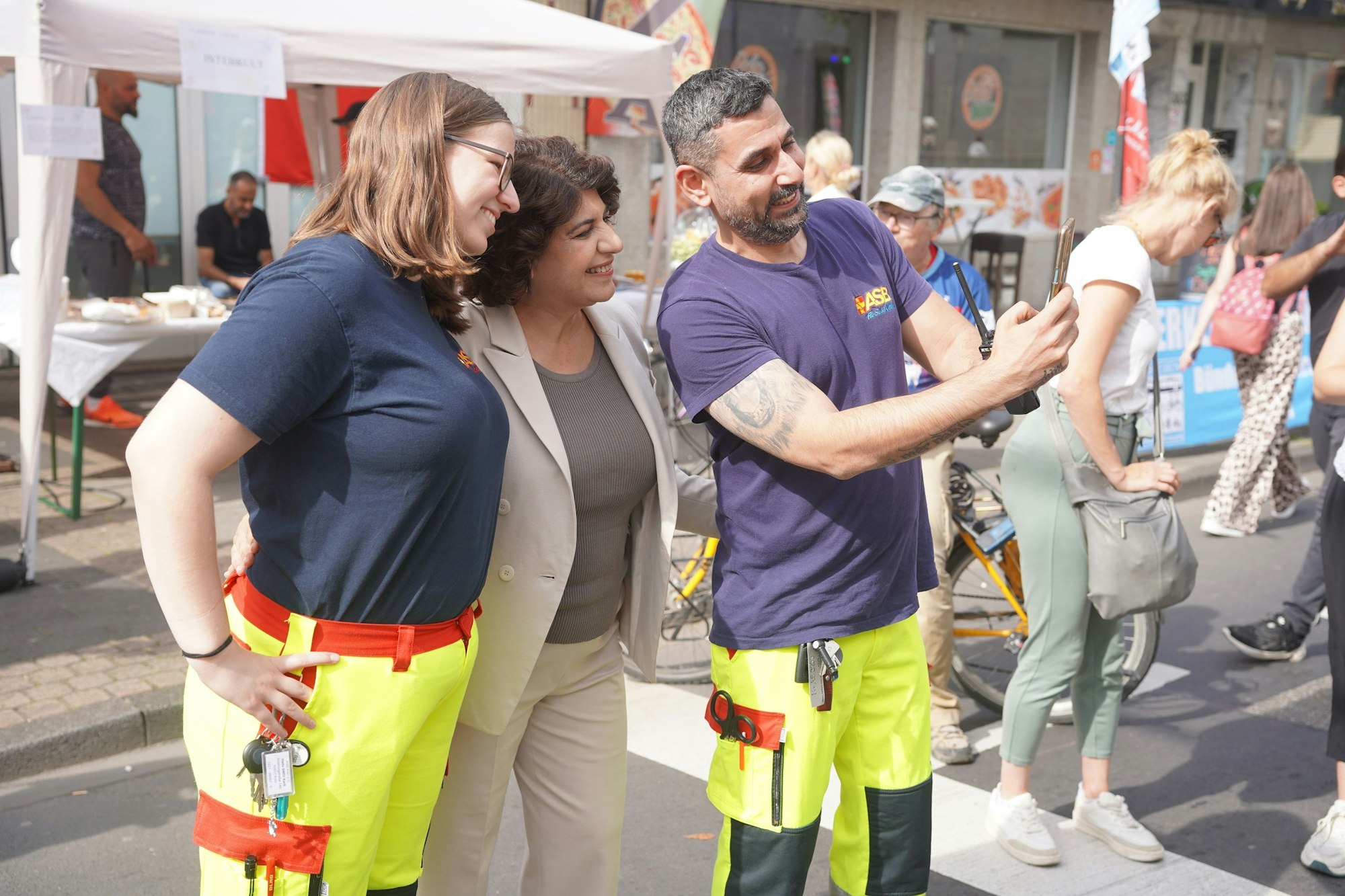 OB-Kandidatin Berivan Aymaz macht Selfies mit zwei Personen.