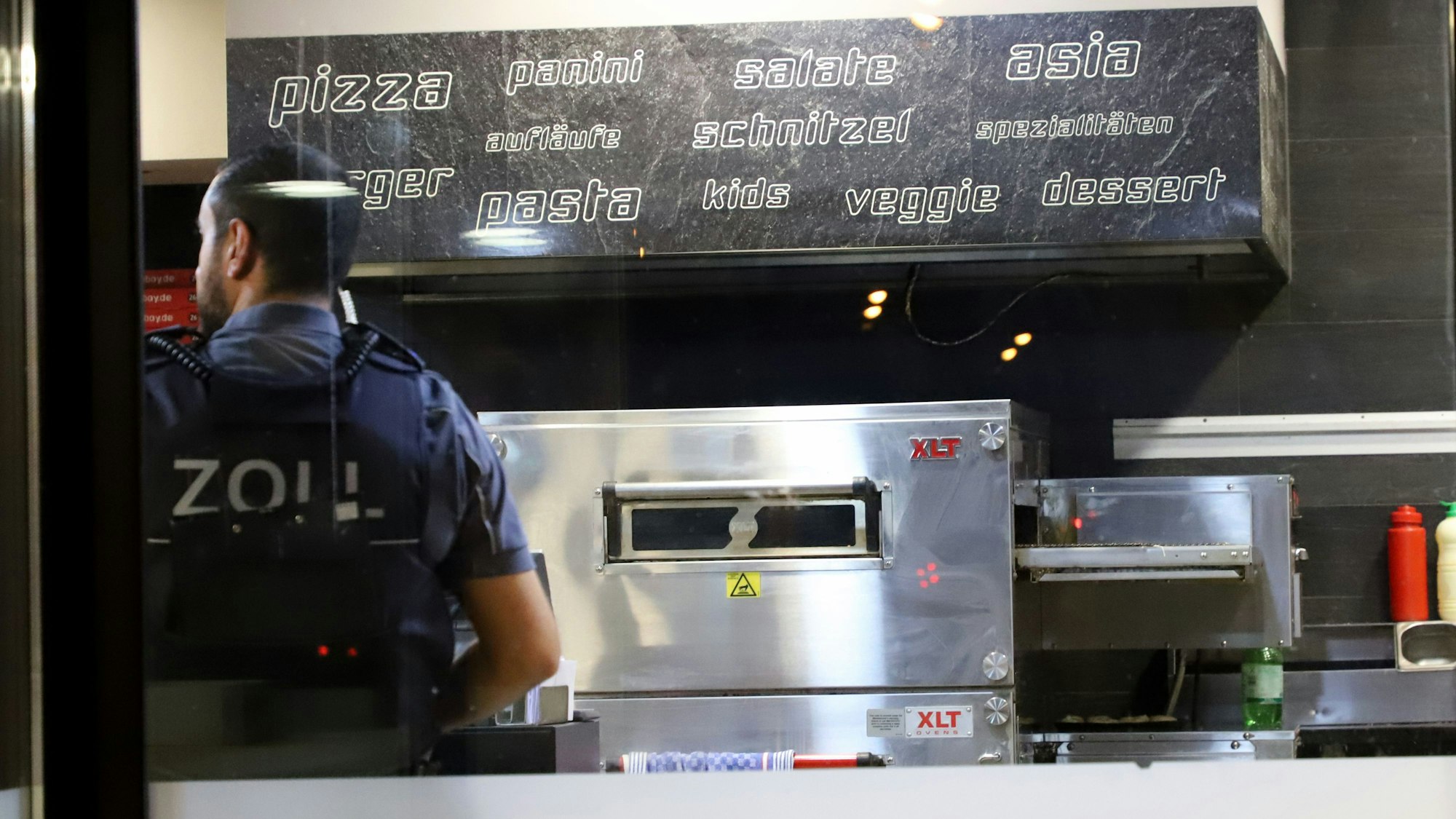 Einsatzkräfte des Zolls bei einer Kontrolle in einer Pizzeria.
