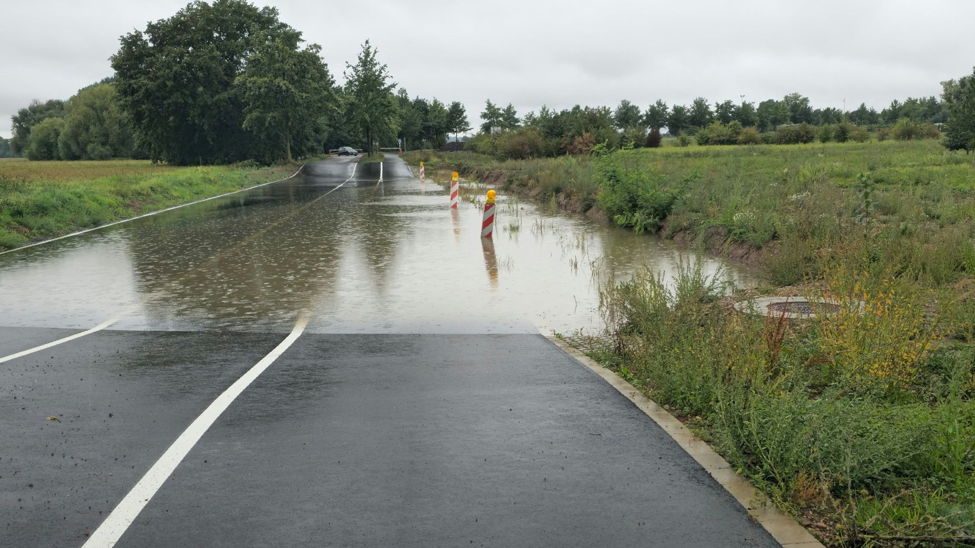 Auf der Straße hat sich Wasser gestaut.