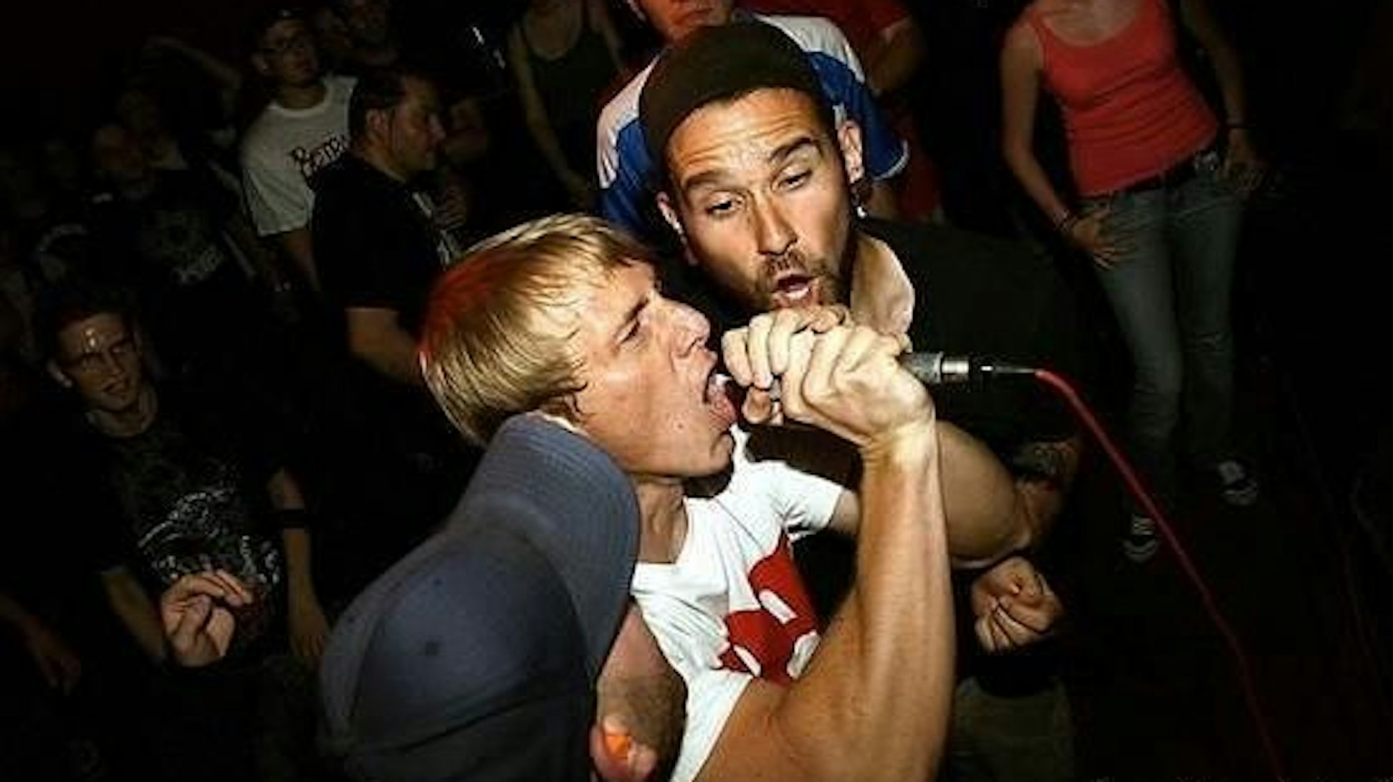 Das Bild zeigt René vom Forced Narrative-Fanzine hat bei einer Show im MTC am Mikrofon. Foto: Torben Utrecht / Allschools Magazine.