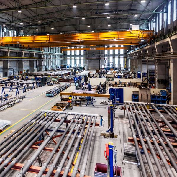 Blick in eine Produktionshalle, in der Rohre geschweißt werden.