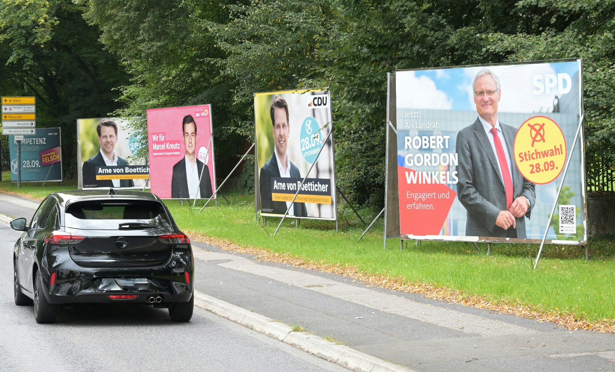 Wahlplakate zur Stichwahl der Kommunalwahl 2025 stehen an der Overather Straße in Bergisch Gladbach-Bensberg.