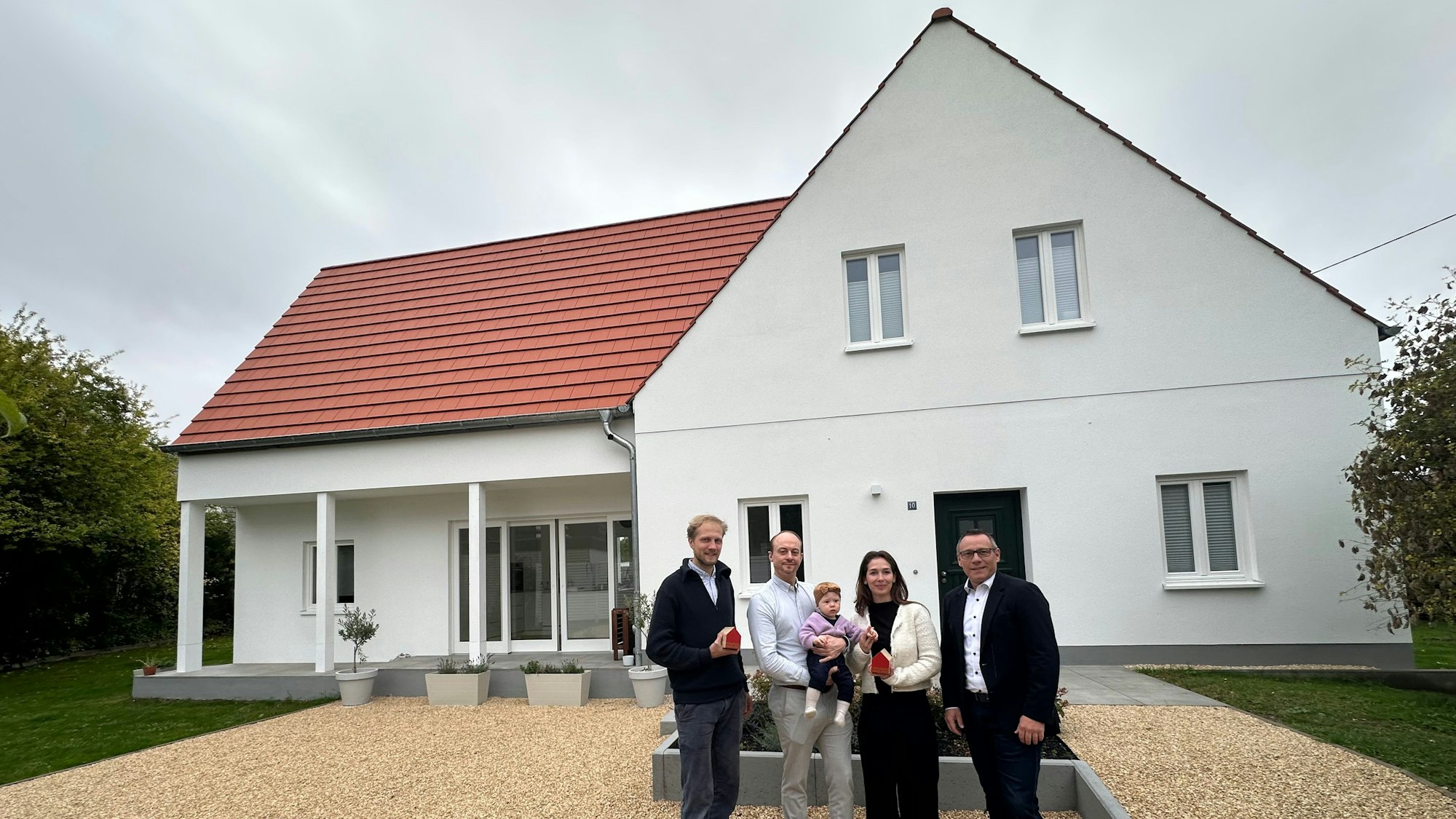 Gruppenfoto vor dem neuen Haus: Architekt Lucas Schrader, Leonard Stühl, Tochter Amilia, Miriam Cockx-Stühl und LBS-Gebietsleiter Thomas Busch (v.r.).