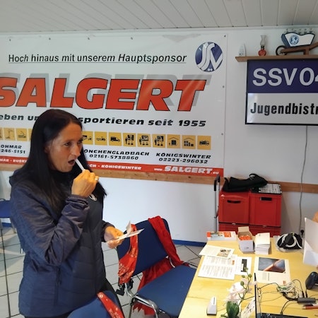 Mit dem Wattestäbchen streicht Claudia Radermacher, Ehrenamtlerin im SSV 04, über die Innenseite ihrer Wange, Leif Stockhausen tütet die Proben ein.