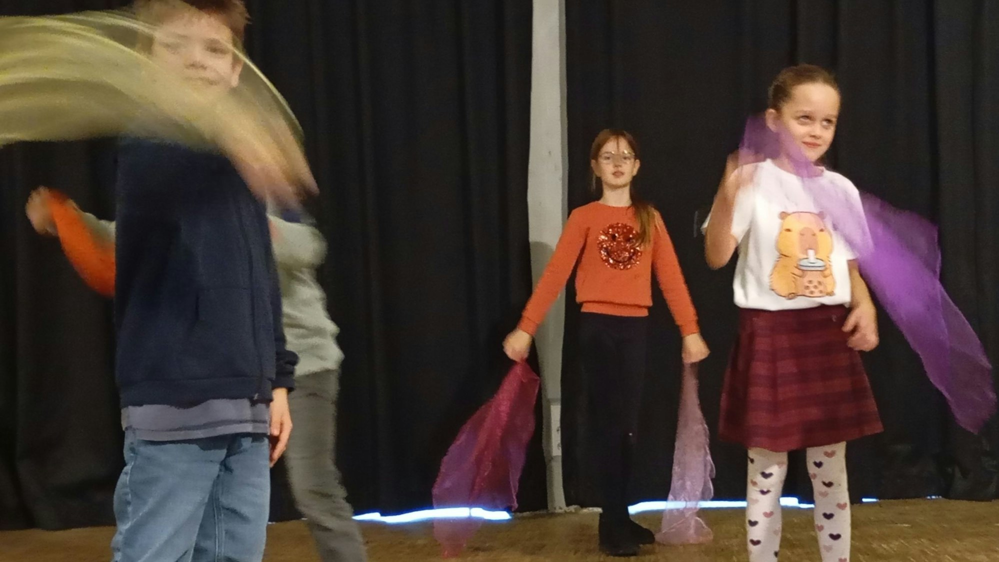 Das Foto zeigt Kinder, die bunte Tücher schwingen.