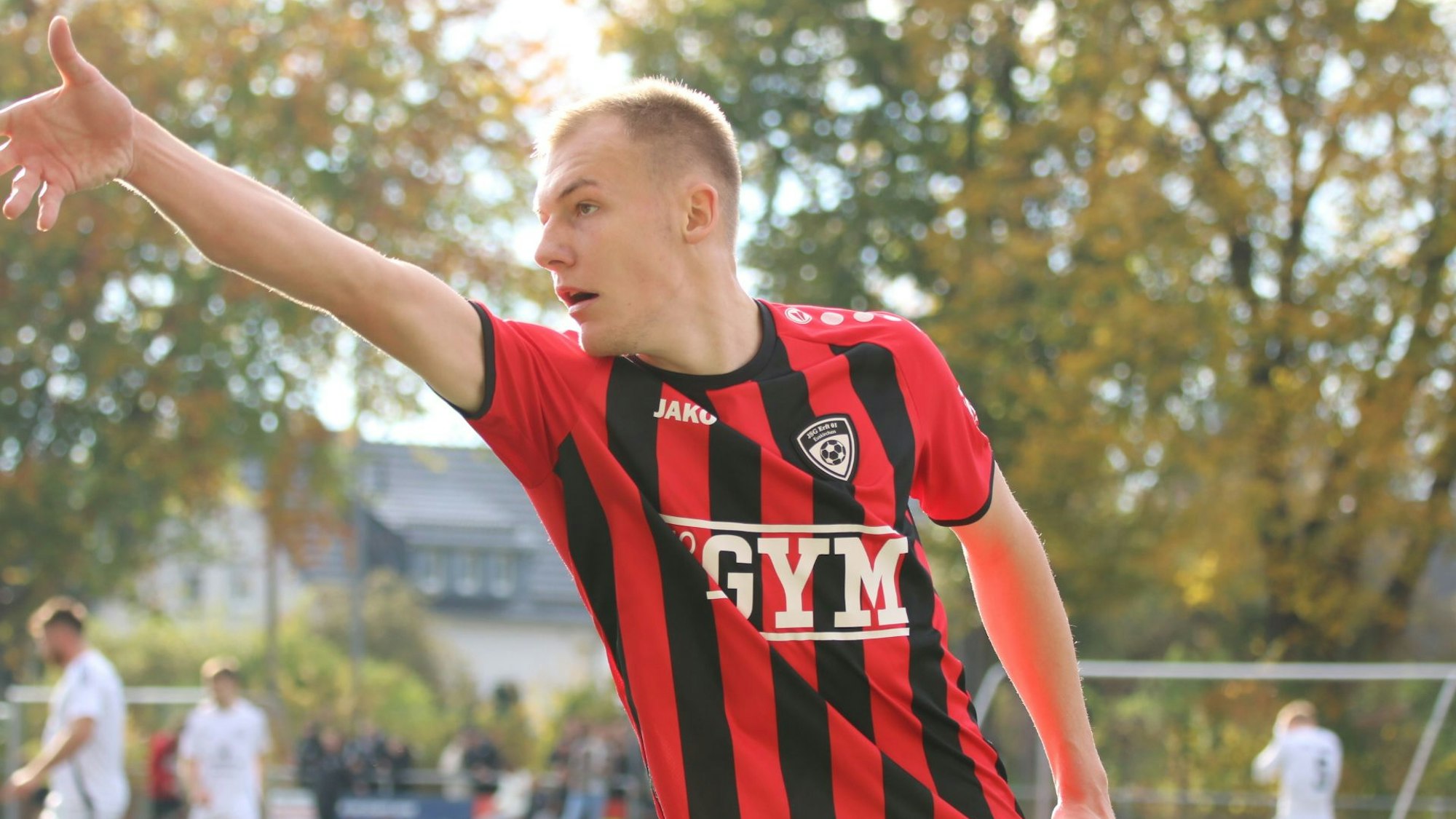 Luke Bungart simuliert beim Torjubel einen Dartwurf.