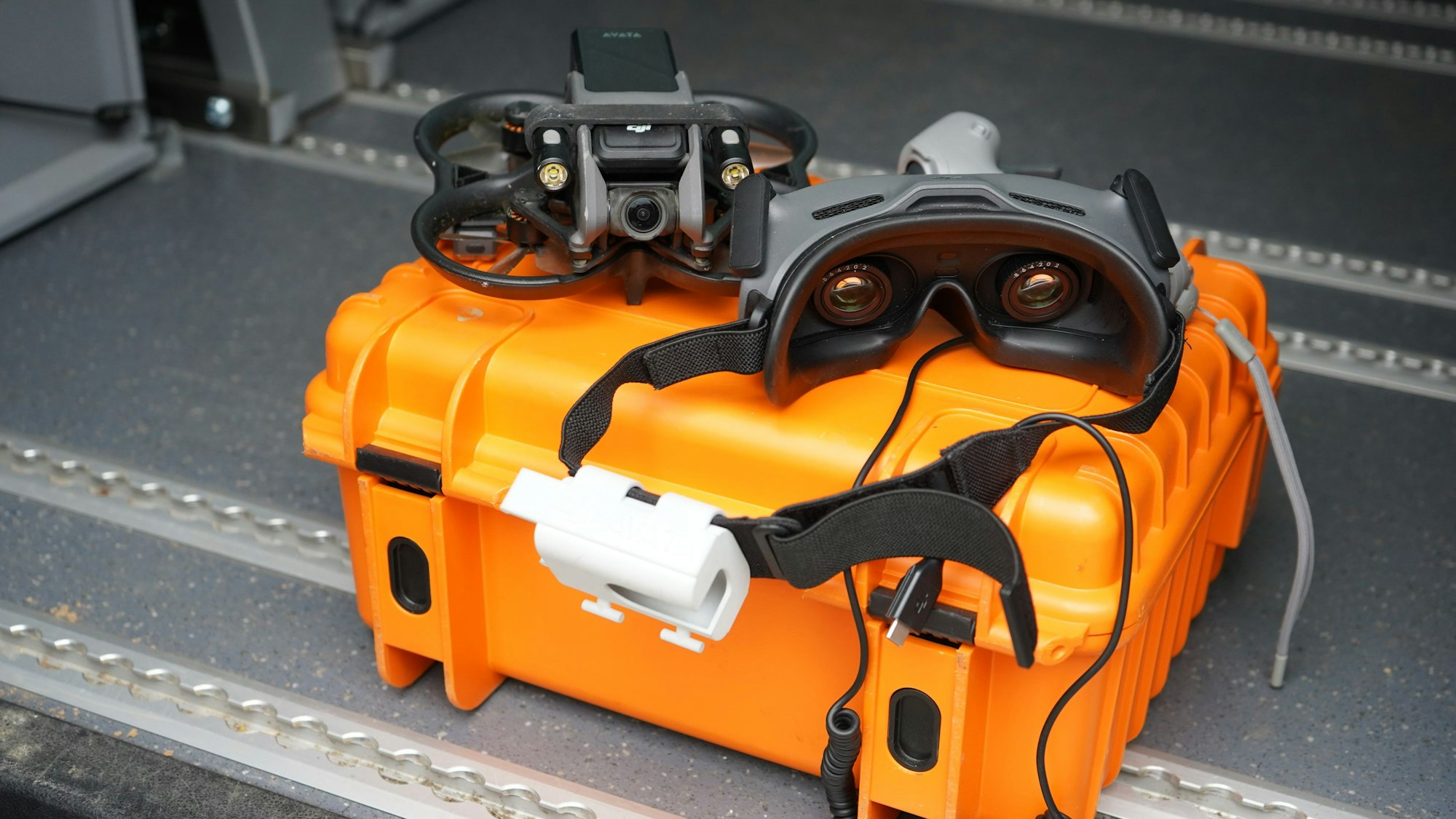 Das Foto zeigt eine Drohne, die auf einem Koffer liegt.