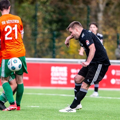 Michael Jansen spielt einen Ball hinter dem Rücken zweier Sötenicher Spieler, die sich gegenseitig behindern.