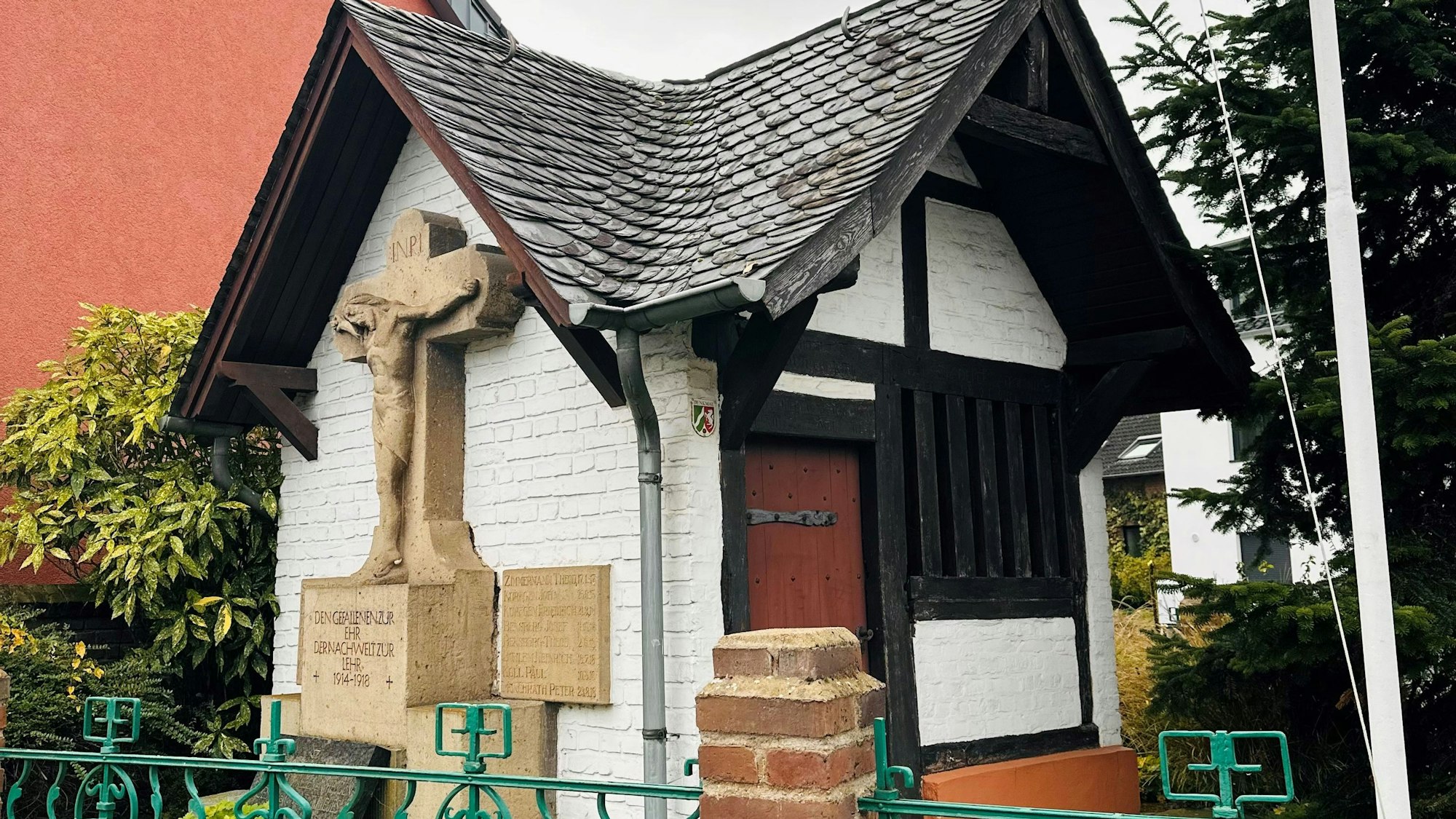 Das Bild zeigt eine kleine Kapelle an einer Straße.