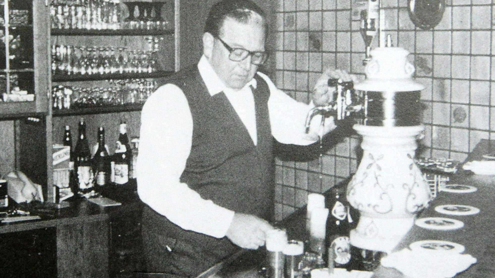 Ein Mann am Zapfhahn in einer Gaststätte