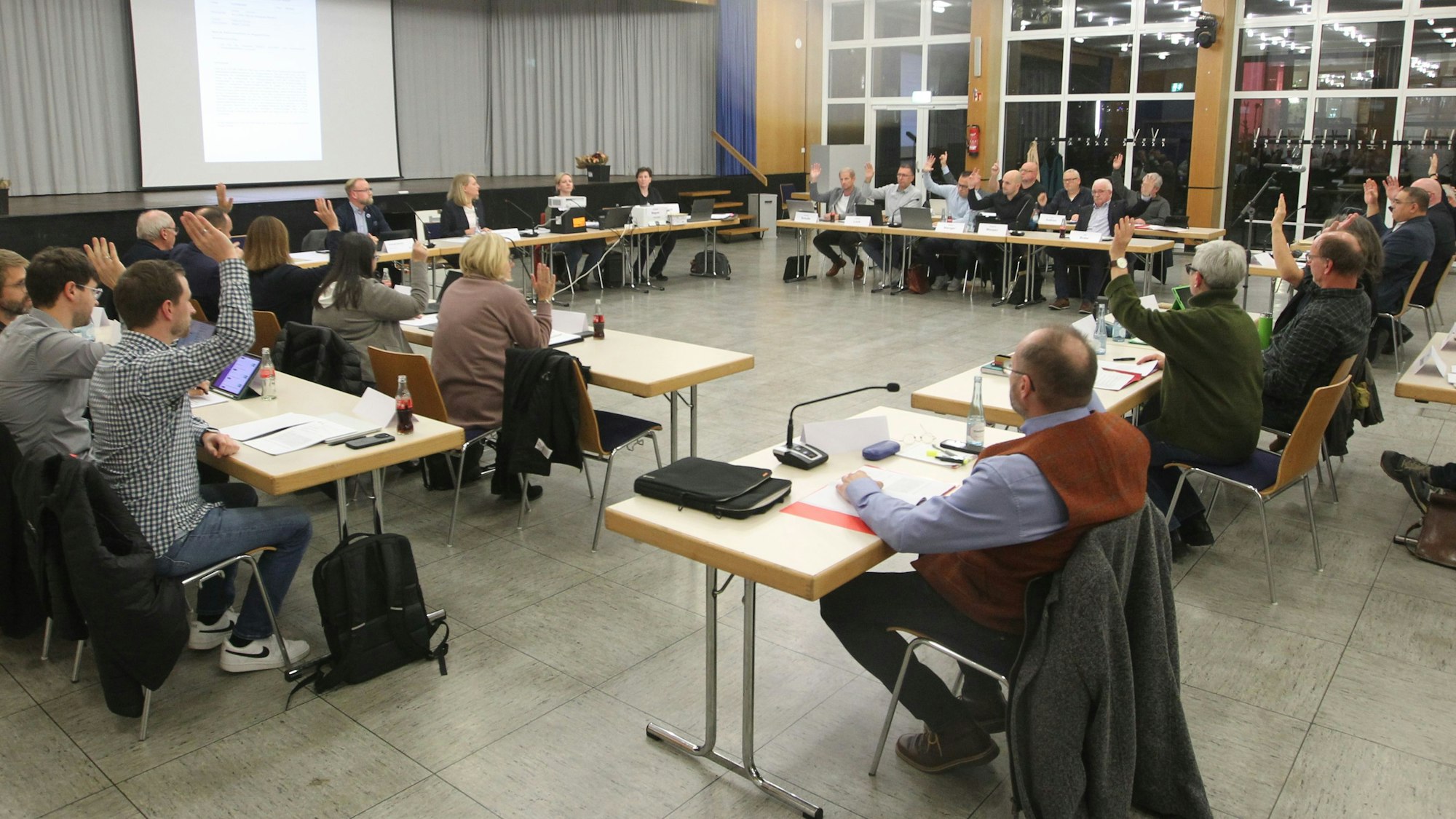 Mitglieder eines Gemeinderats bei einer Abstimmung.