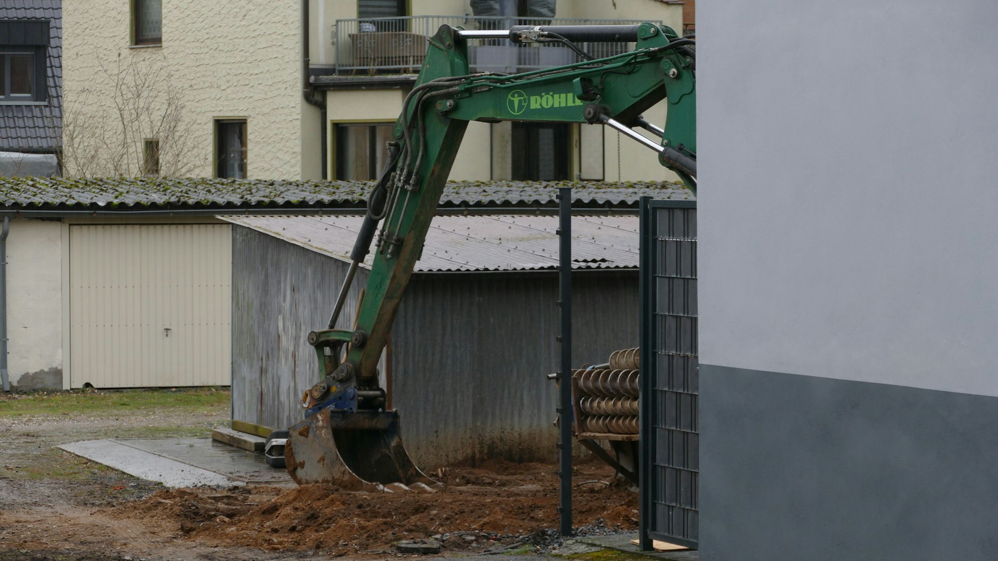 Ein Bagger eines spezialisierten Tiefbauunternehmens steht in dem Hinterhof, wo der Blindgänger entdeckt wurde.
