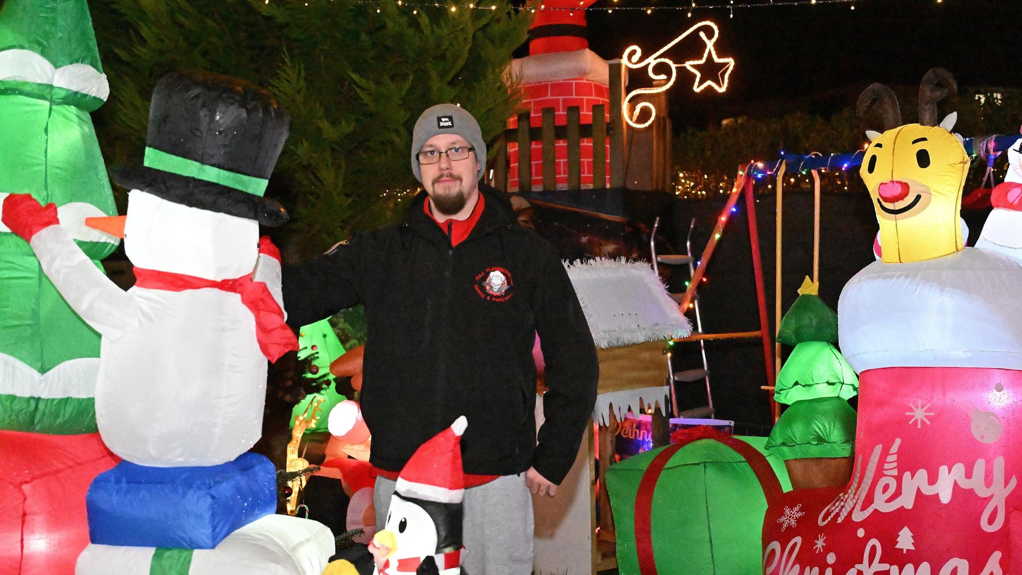 David Münch-Oberheuser steht inmitten seiner riesigen Weihnachtsdeko im Garten.