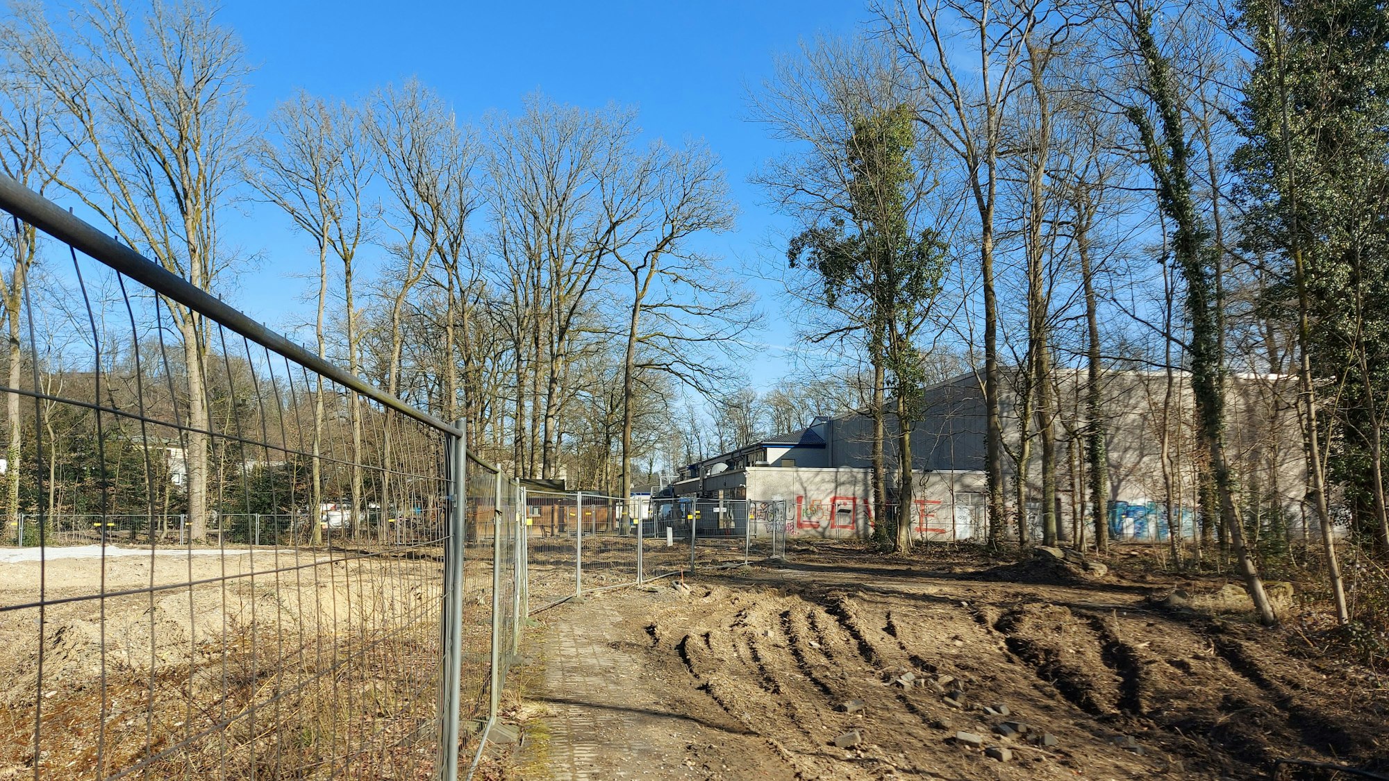 Eine Baustelle, dahinter ein Schulzentrum.