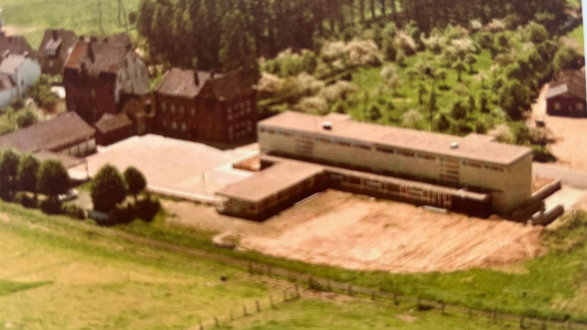 Links ist die alte Schule zu sehen, rechts der später hinzugekommene Neubau, der heute noch steht.