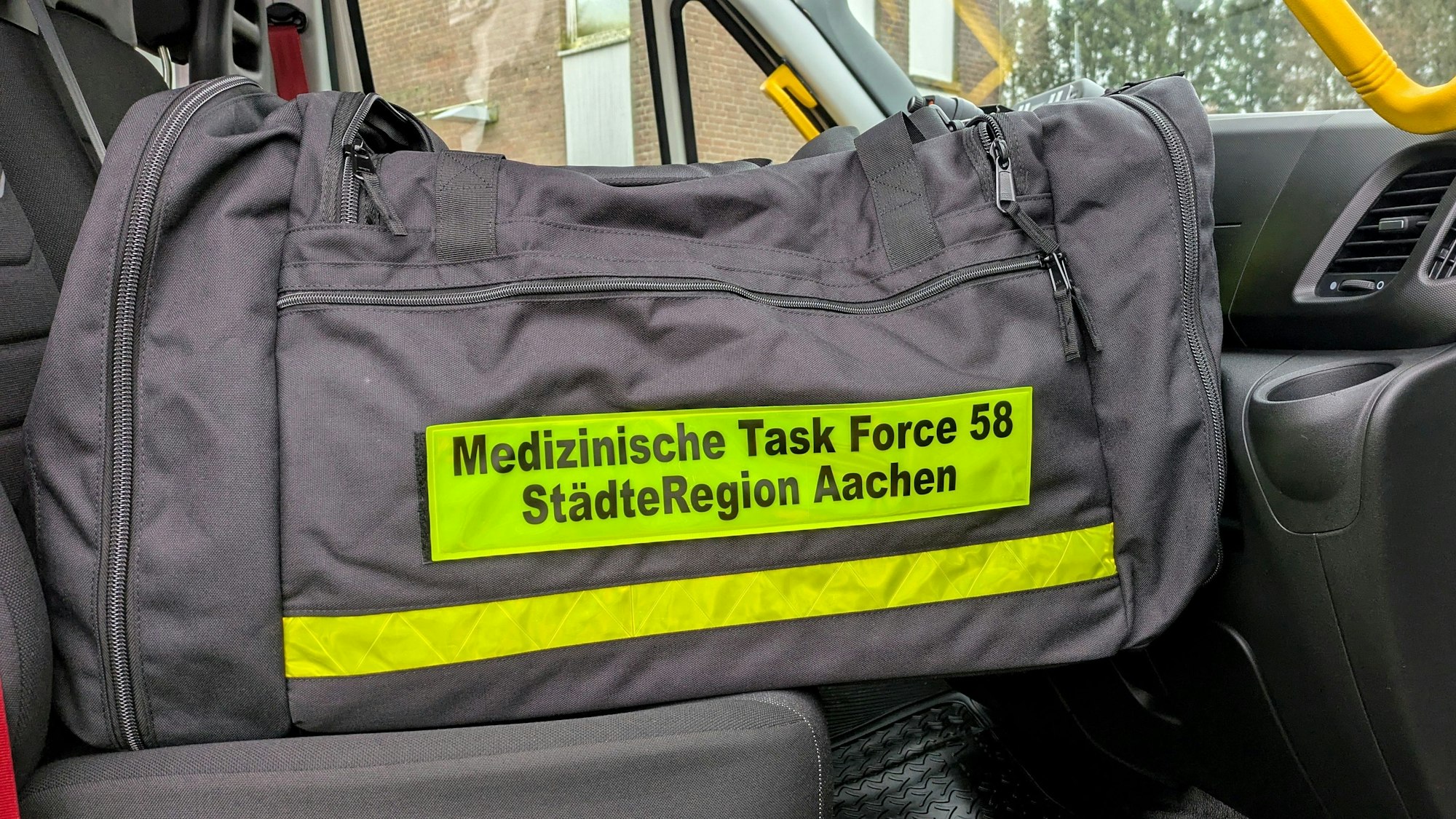 Auf einer schwarzen Tasche befindet sich ein Aufnäher mit der Aufschrift Medizinische Task Force 58 StädteRegion Aachen.