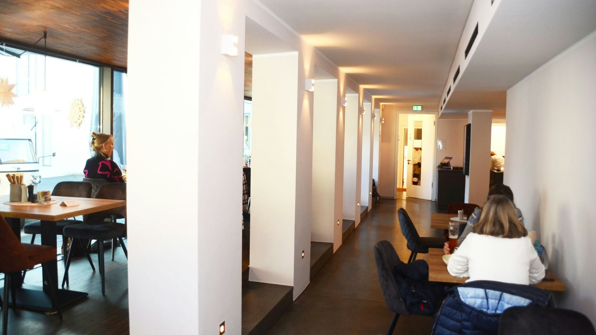 Gäste sitzen an Tischen in einem Restaurant.