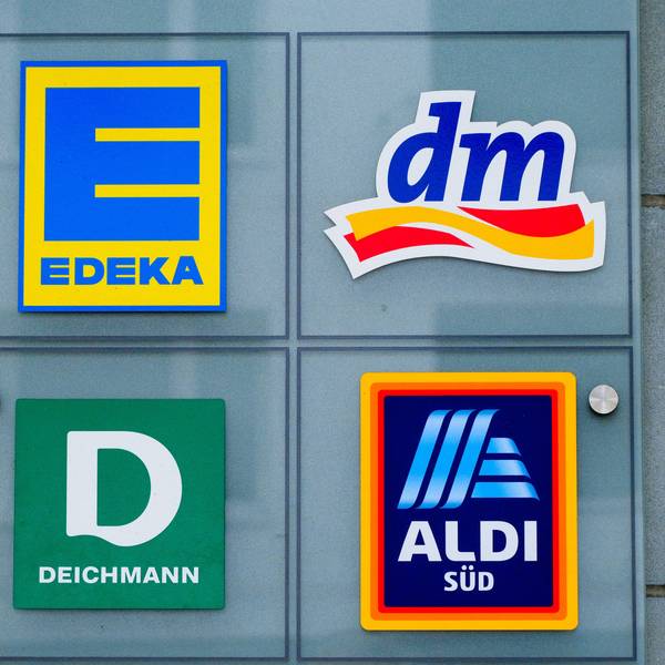 Logos von Edeka und dm.