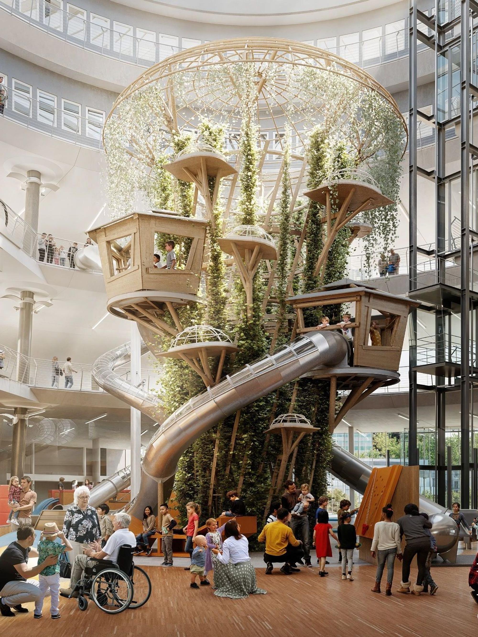 Die Visualisierung dee künftigen Erlebniswelt Exploradom zeigt das große Atrium im Kern des Gebäudes in Ehrenfeld, das ab Januar umgebaut wird. EIn riesiger Kletterbaum mit kleinen Baumhäusern streckt sich unter der Glaskuppel in die Höhe, dazu Rutschen, die unter anderem als Verbindung vom zweiten Obergeschoss ins Erdgeschoss dienen.