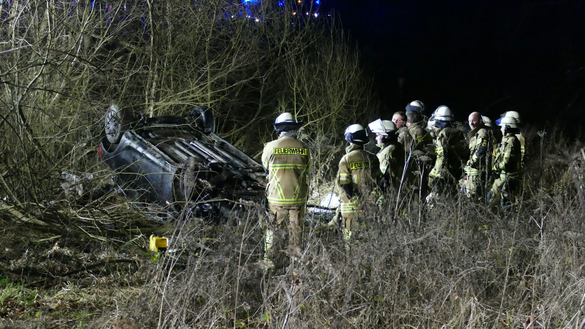 Feuerwehrleute begutachten das Wrack.