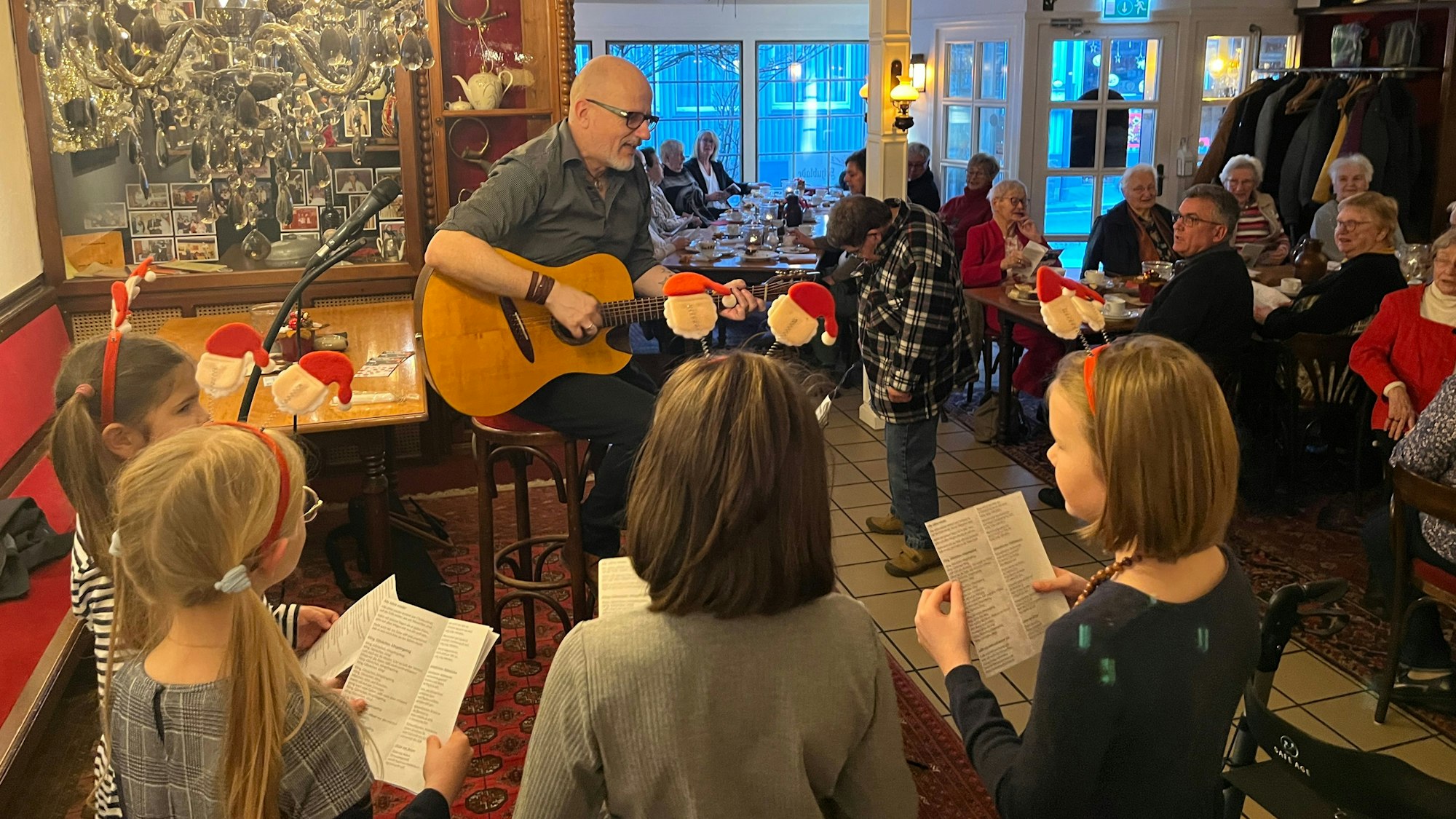 Paul Radau sang mit vier engagierten Kindern bei der Weihnachtsfeier für Alleinstehende in der Schublade in Much Weihnachtslieder.