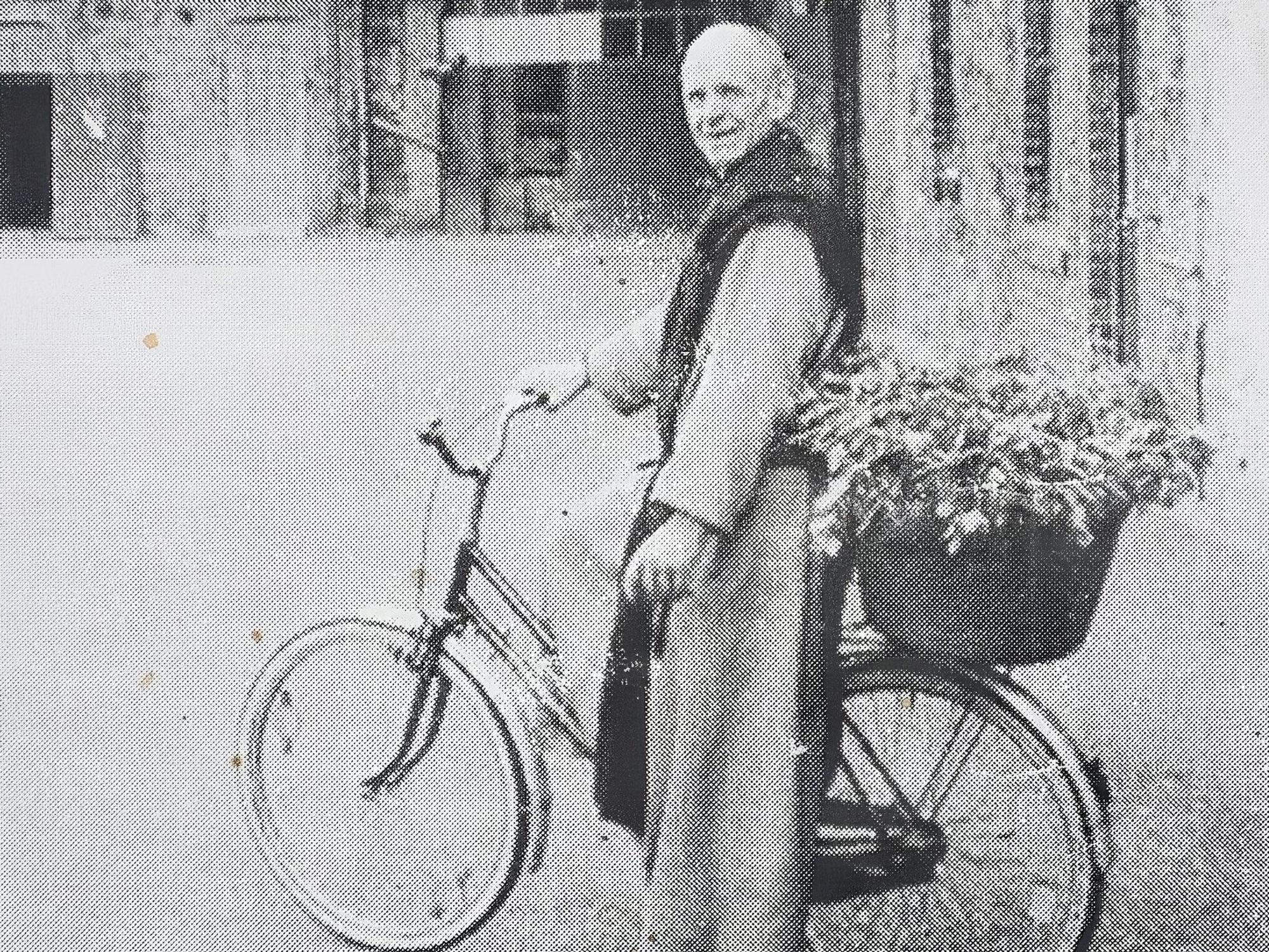 Ein altes Foto von Bruder Clemens, wie er mit seinem Fahhrad im Innenhof von Kloster Mariawald steht, auf dem Träger hat er einen Korb voller Gemüse.