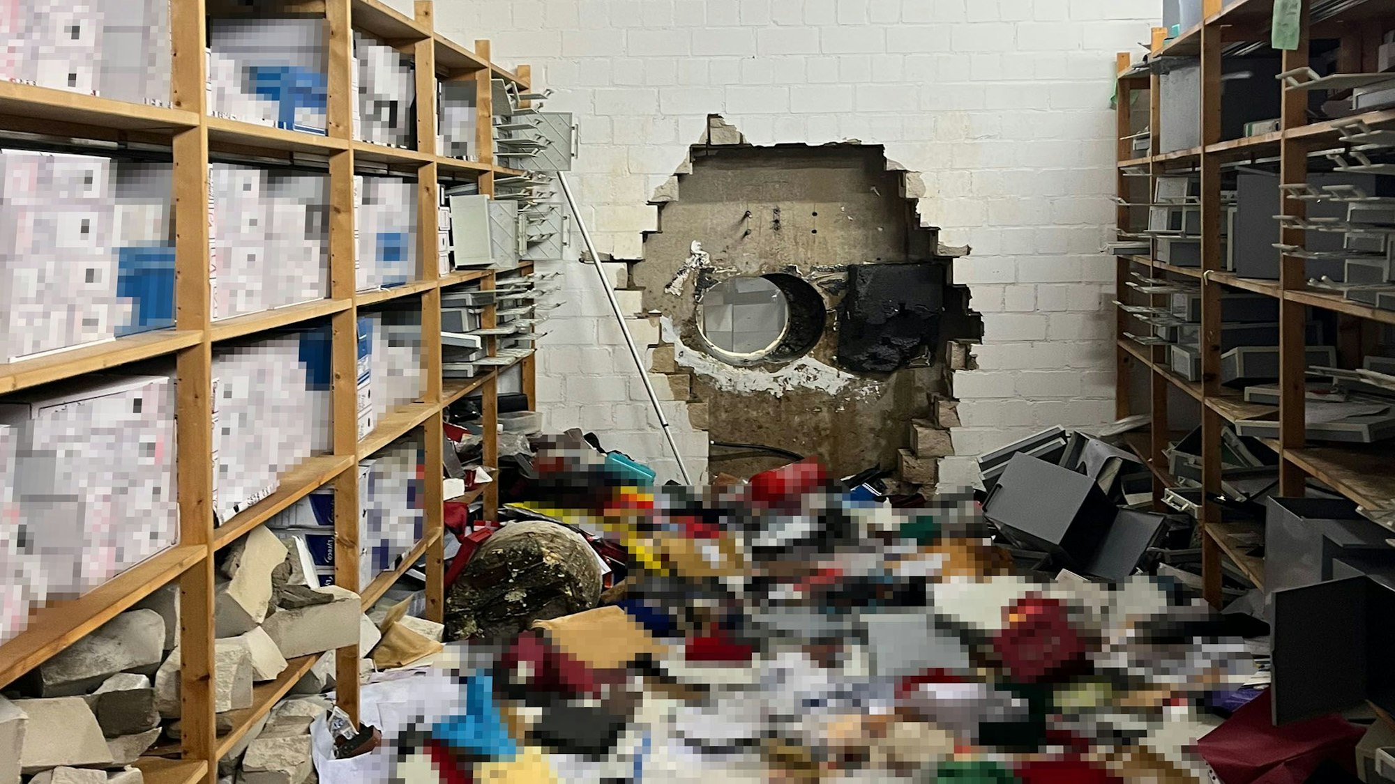 Ein großes Loch ist in der Wand des Tresorraums einer Sparkasse zu sehen.
