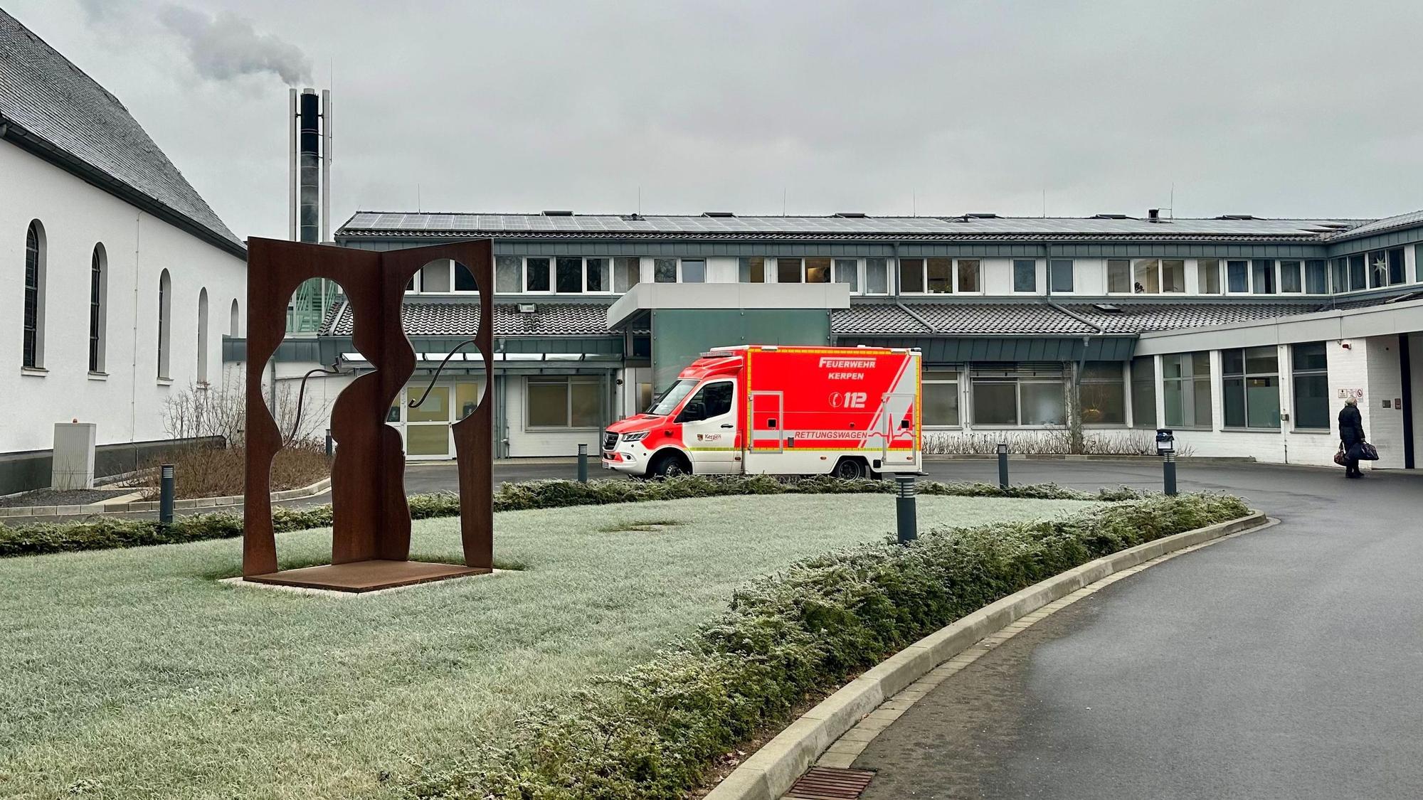 Zu sehen ist ein Rettungswagen vor einem Krankenhaus.