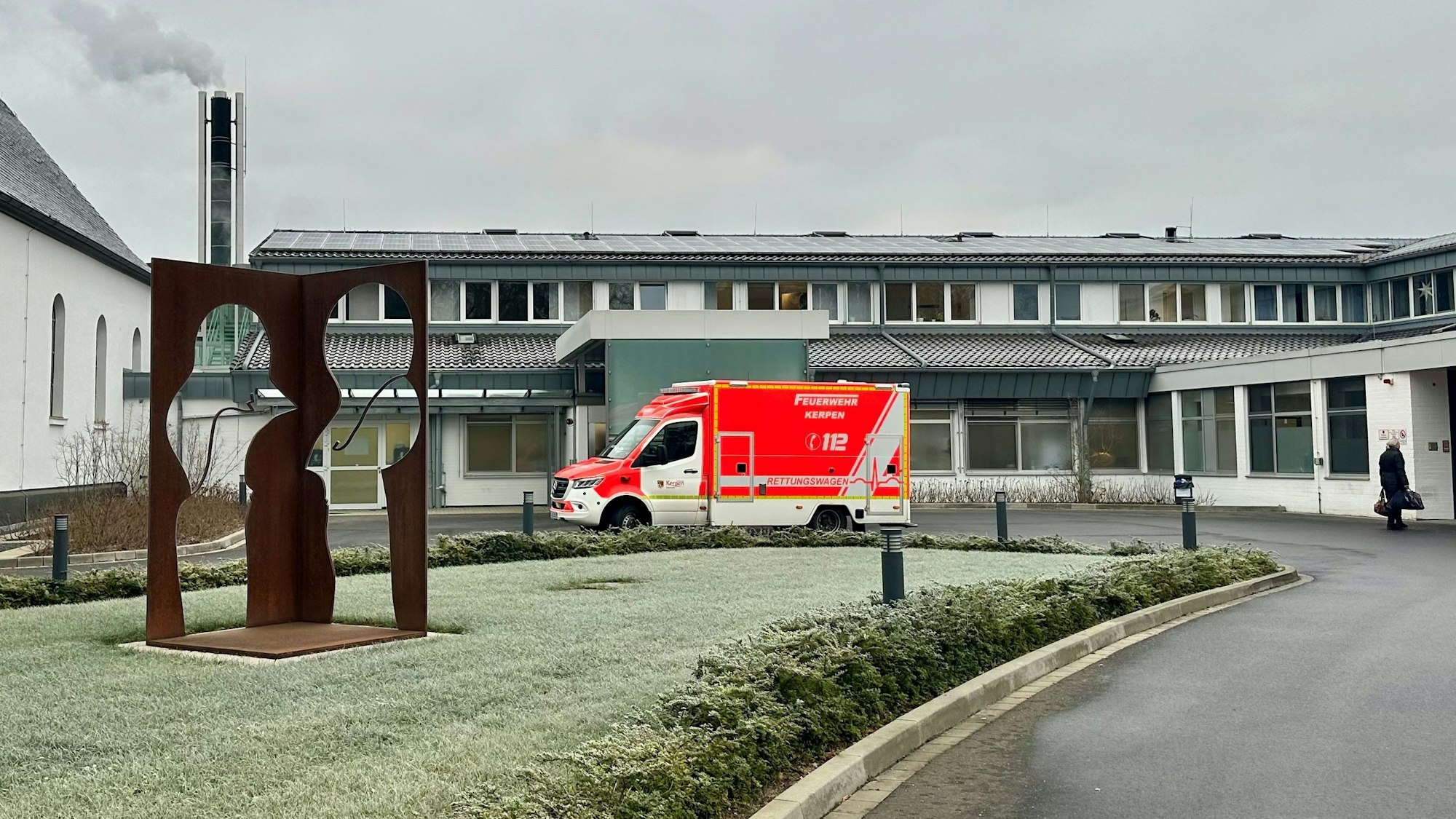 Ein Rettungswagen steht vor einem Krankenhaus.