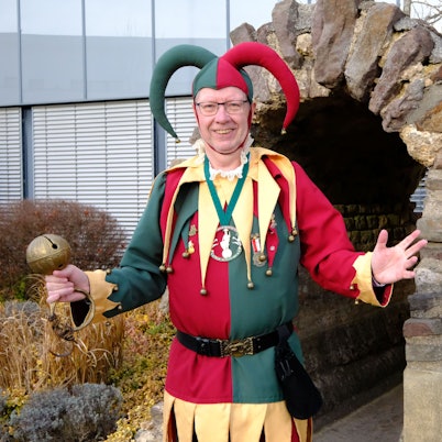 Dirk Gemünd aus Mechernich steht in seinem Kostüm als Kölner Bellejeck vor dem Römerkanal-Denkmal am Mechernicher Rathaus.