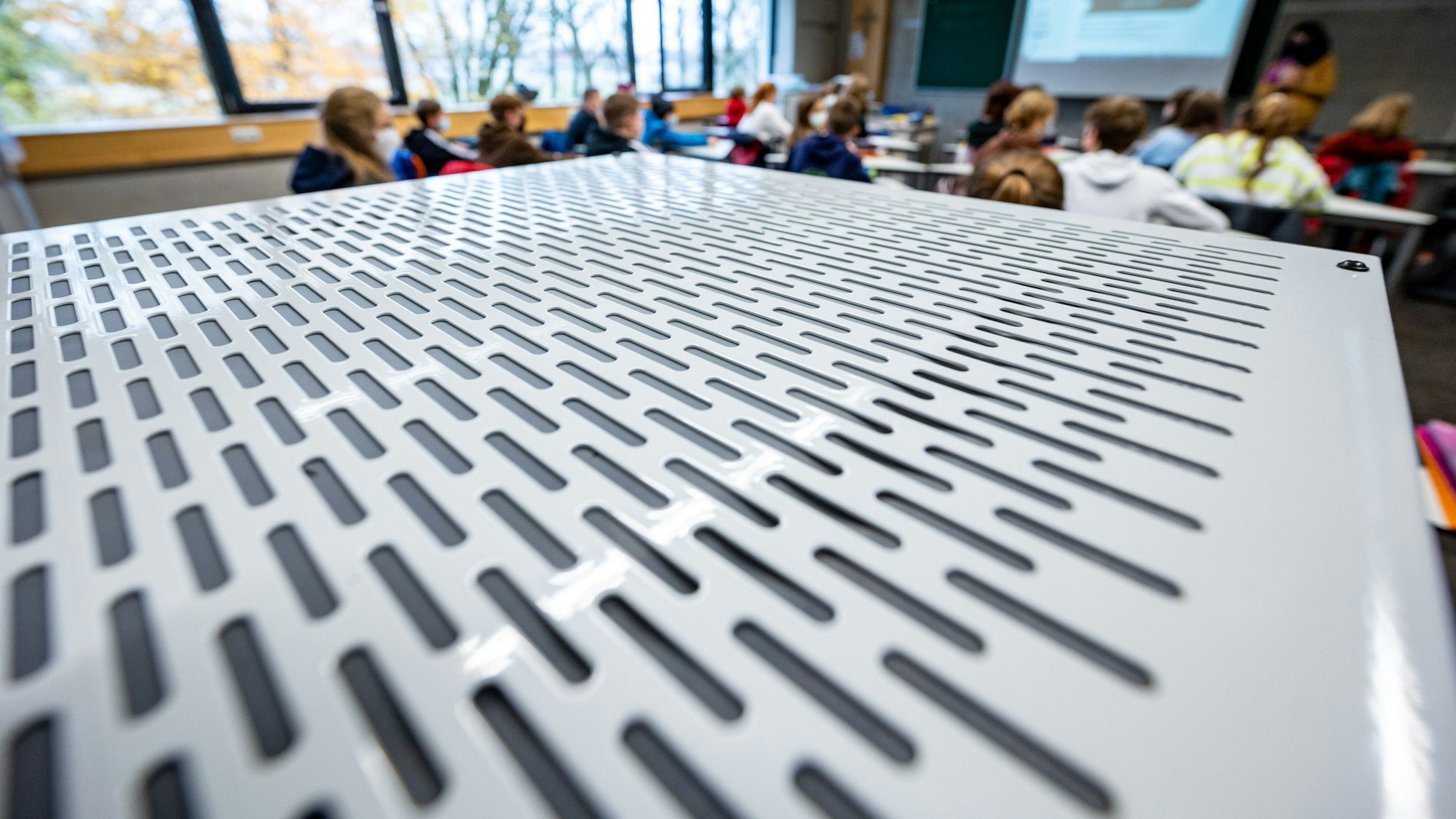 Ein Luftfiltergerät steht in einem Klassenzimmer.