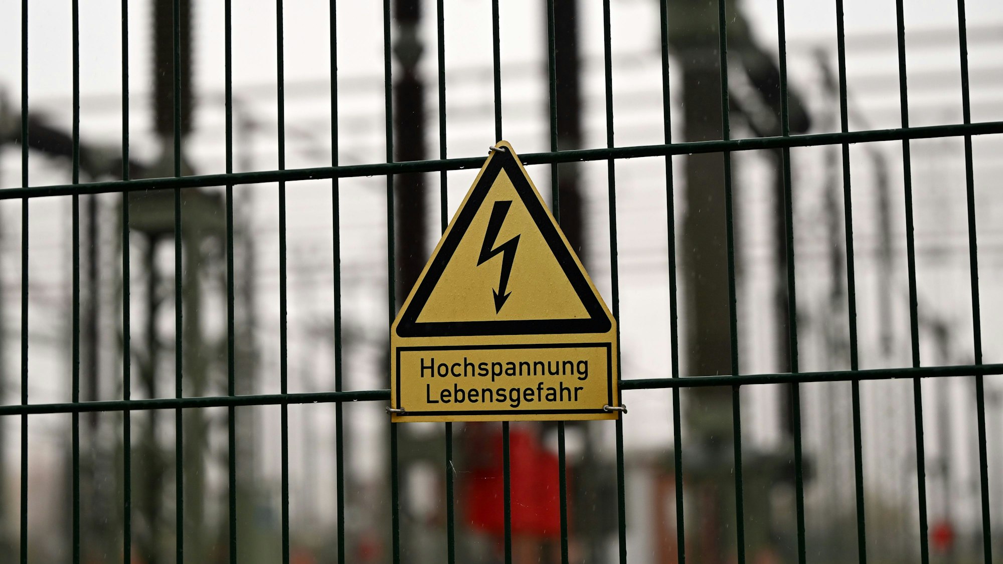 ARCHIV - 10.11.2025, Brandenburg, Potsdam: Ein Schild mit der Aufschrift "Hochspannung Lebensgefahr" hängt am Zaun des Umspannwerks von 50Hertz in Neuenhagen.