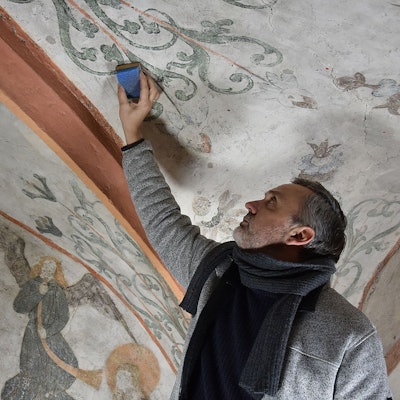 Das Foto zeigt Restaurator Christian Rubin bei der Arbeit in der Kirche in Nümbrecht-Marienberghausen.
