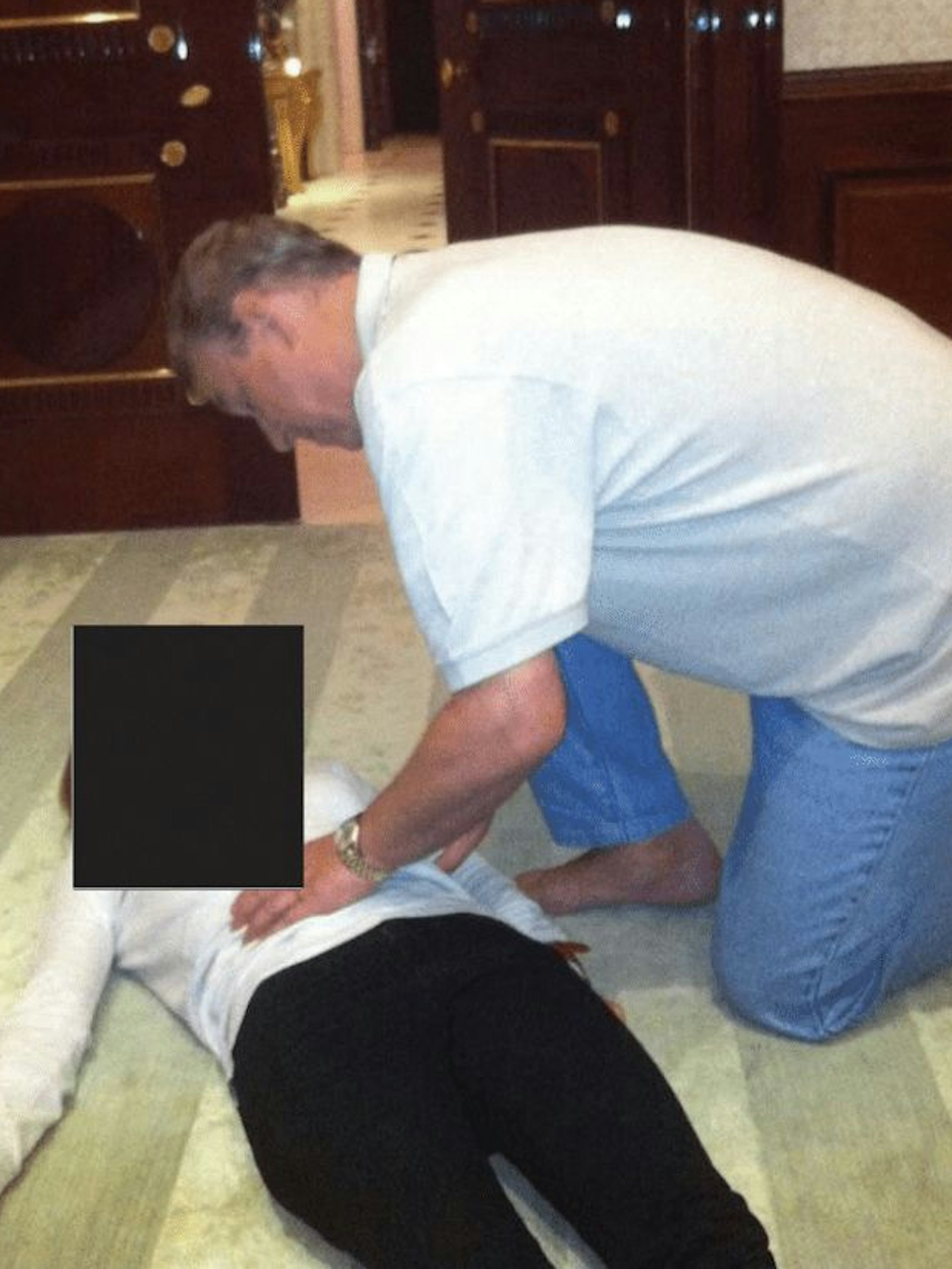 Ex-Prinz Andrew beugt sich über Frau.