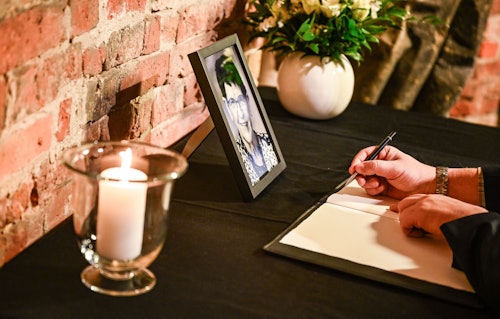 03.02.2026, Berlin: Ein Mann schreibt ins Kondolenzbuch für die verstorbene ehemalige Bundestagspräsidentin Rita Süssmuth im Deutschen Dom.