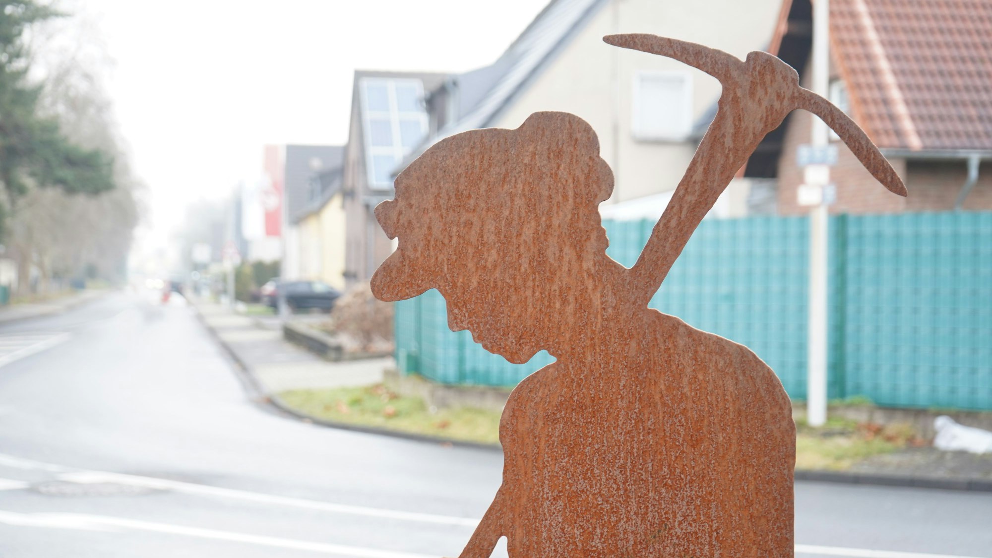 Die Silhouette eines Bergarbeiters steht zwischen Auenheim und Niederaußem in Kraftwerksnähe.