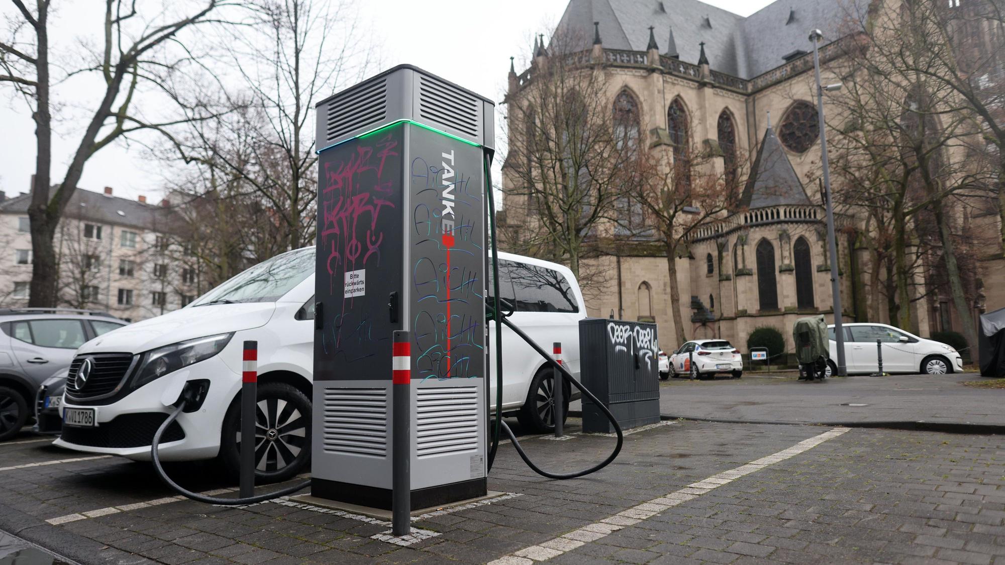 Ein Elektroauto steht an einer Ladesäule im Agnesviertel, die bereits mehrfach beschädigt wurde.