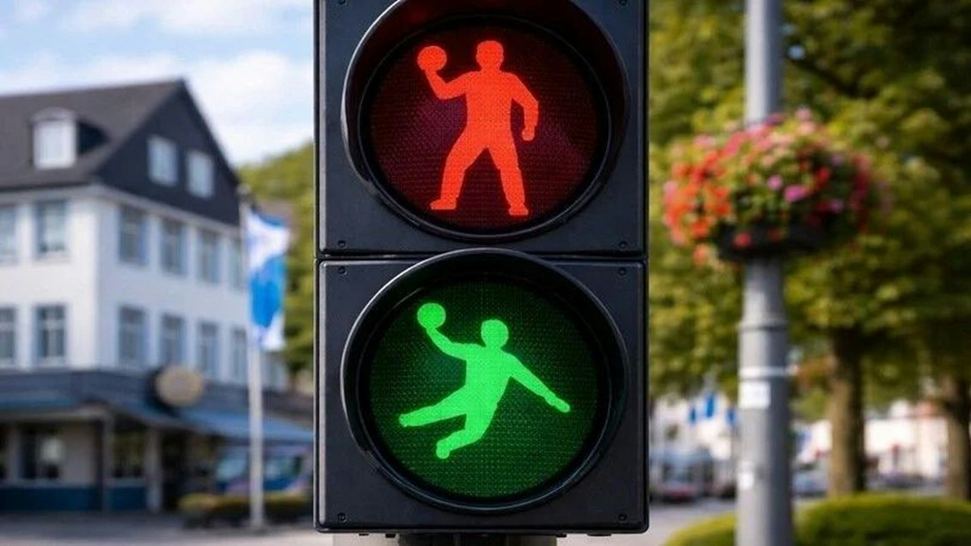 Handballer auf einer Ampel.