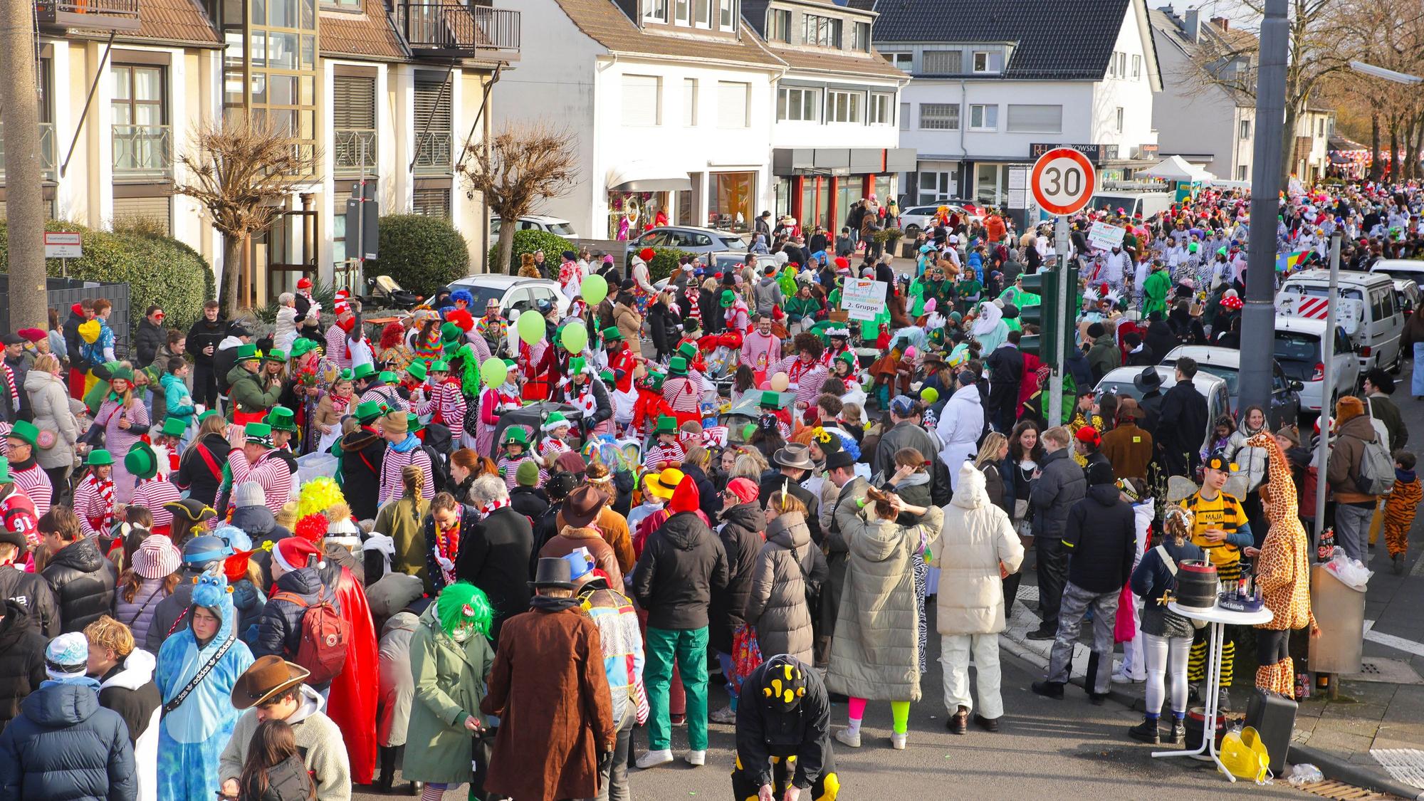 Eine Straße ist voll mit kostümierten Menschen.