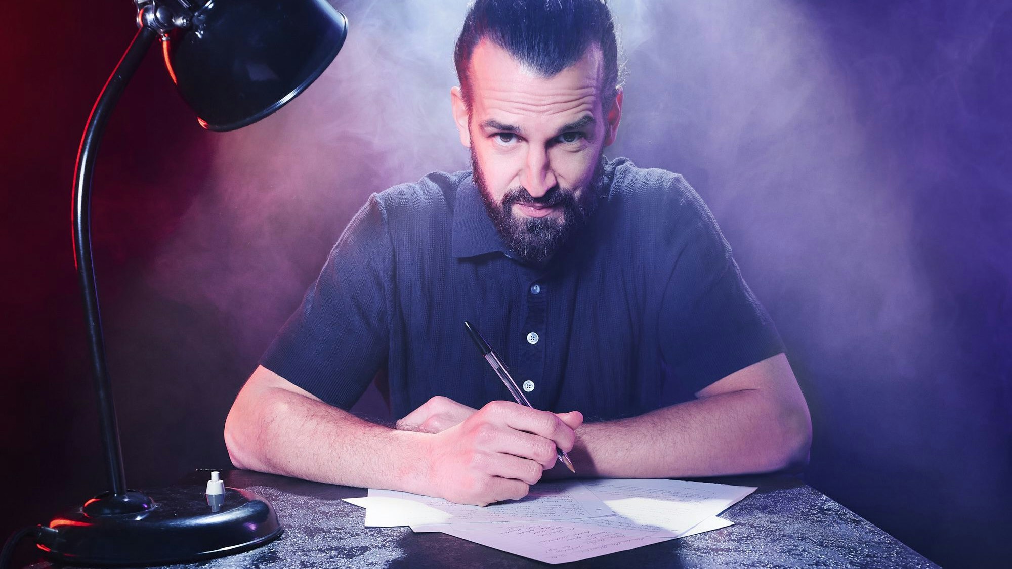 Ein Mann blickt geheimnisvoll in die Kamera.