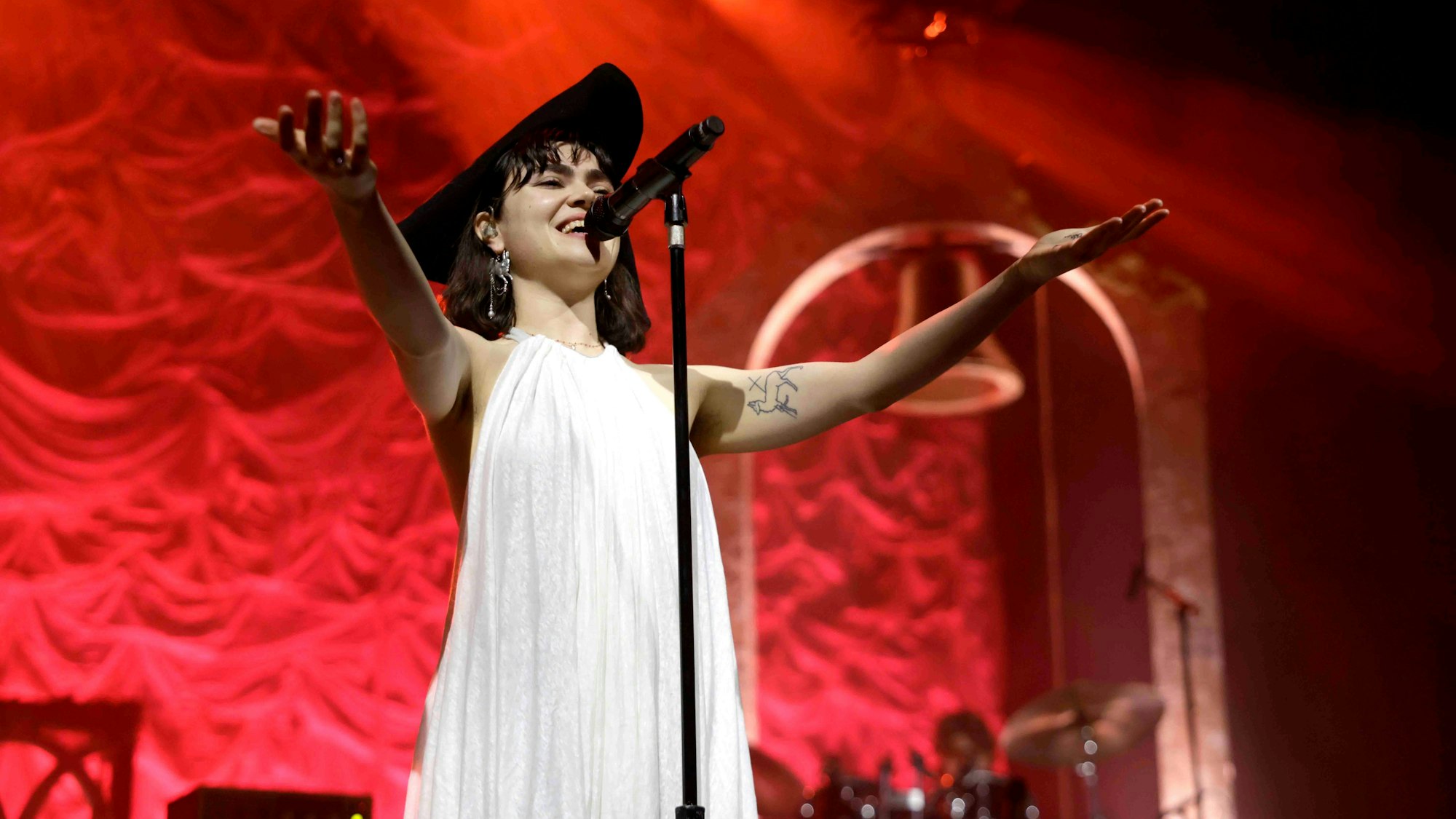 Im weißen Hängerkleid und mit schwarzem Dreispitz: The Last Dinner Party-Sängerin Abigail Morris.