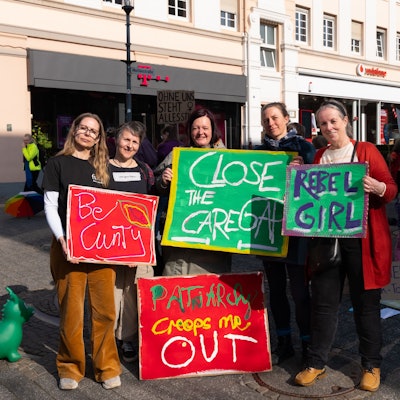 Fünf Frauen mit bunten Plakaten für Frauenrechte auf dem Lindenplatz in Gummersbach.
