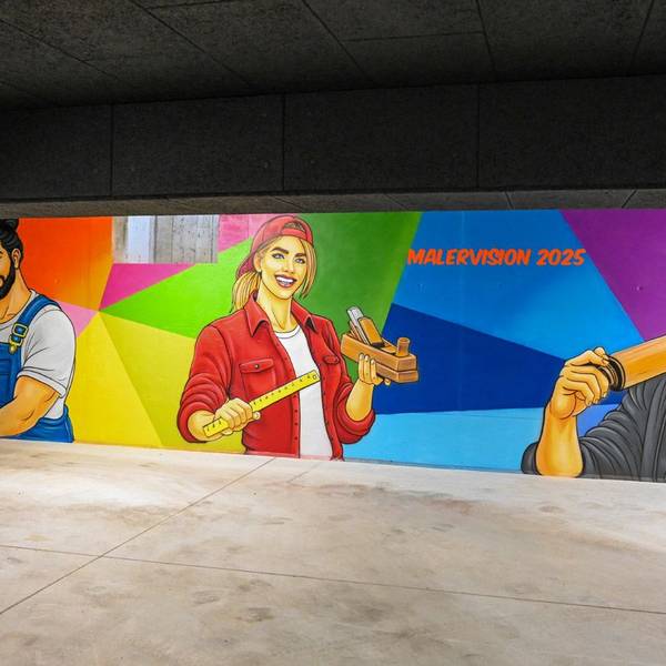 Das Foto zeigt ein Graffiti mit jungen Handwerkern als Motiv
