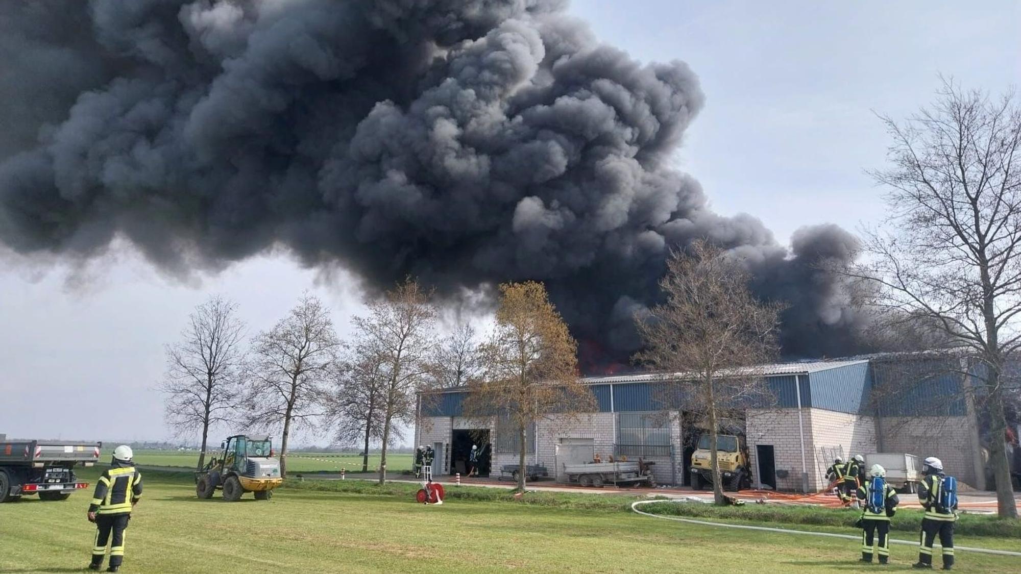 Großbrand in Niederkassel-Rheidt: Dicke Rauchwolken über einer Lagerhalle.