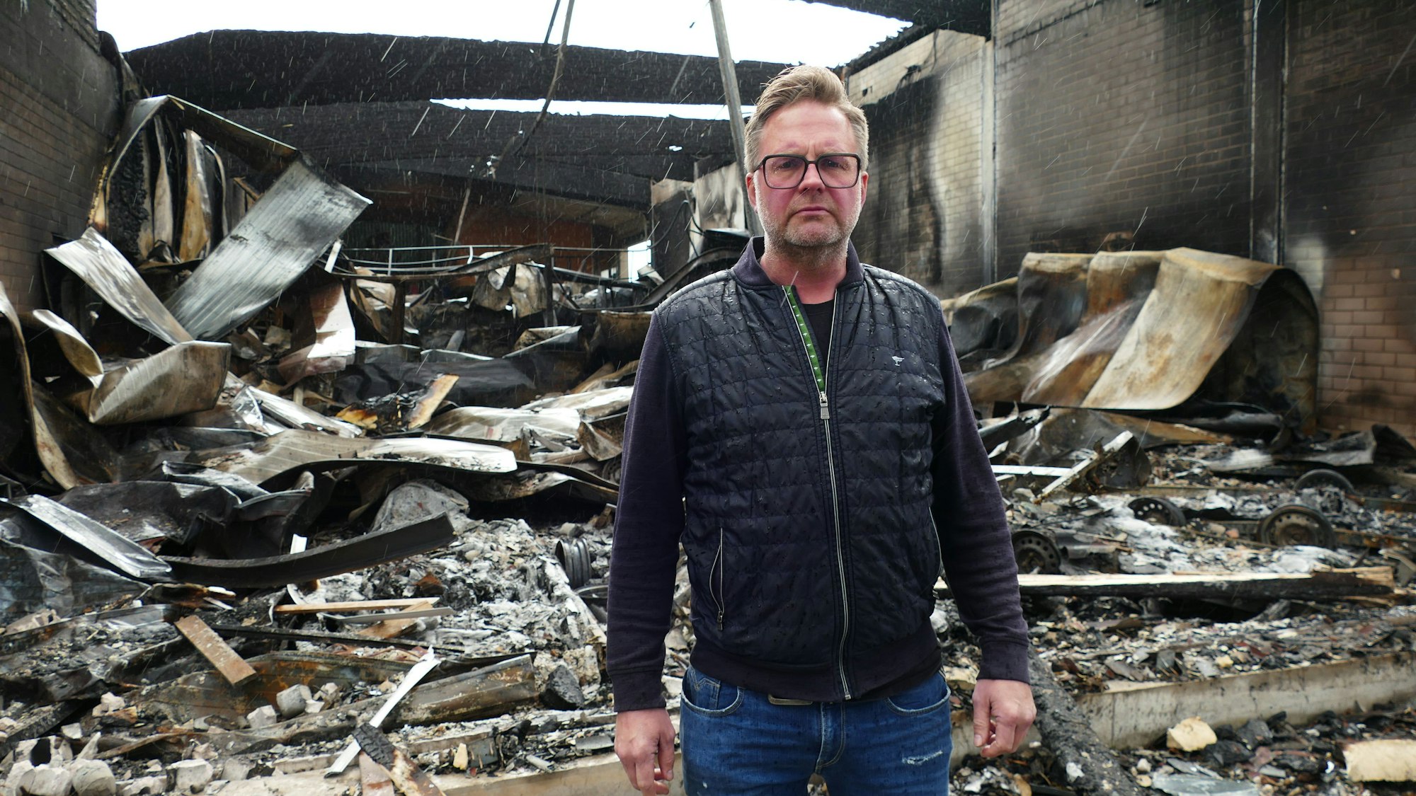 Sascha Wiedenhöfer, bekannt als „Mr. Jet“, steht vor den Trümmern seiner ausgebrannten Jetski-Werkstatt.