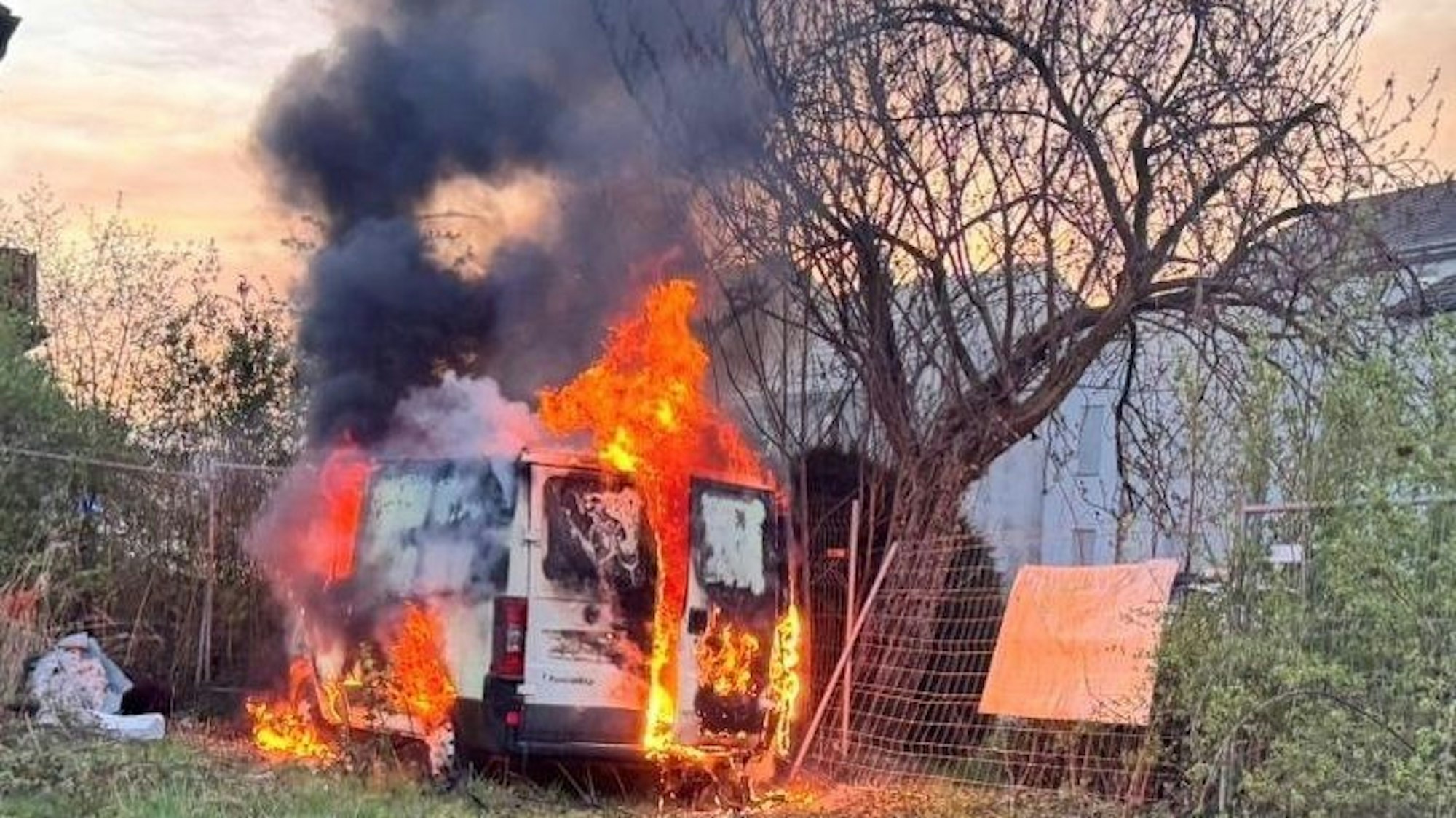 Flammen schlagen aus einem weißen Lieferwagen.