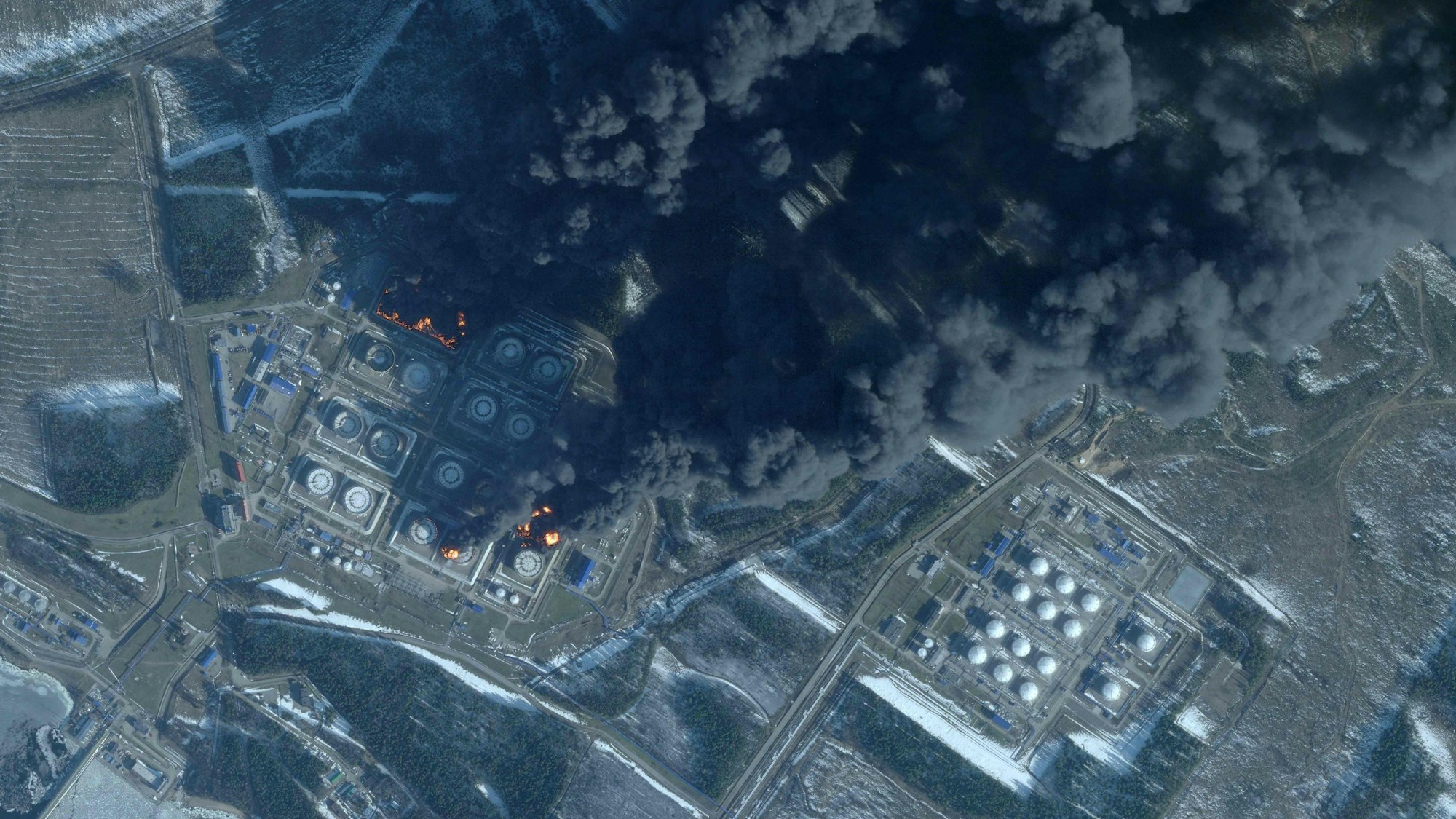 This handout satellite image taken on March 23, 2026 by Planet Labs PBC shows smoke rising from the Russian oil terminal at Primorsk, the most important Russian loading port in the Baltic Sea, following a drone attack claimed by Ukraine. The Russian port of Primorsk, near the Finnish border, suffered damage in the latest round of drone attacks, the region's governor announced on March 23, 2026, with Ukraine claiming responsibility. (Photo by 2026 Planet Labs PBC / AFP) / RESTRICTED TO EDITORIAL USE - MANDATORY CREDIT "AFP PHOTO / (C) 2026 PLANET LABS PBC " - HANDOUT - NO MARKETING NO ADVERTISING CAMPAIGNS - DISTRIBUTED AS A SERVICE TO CLIENTS