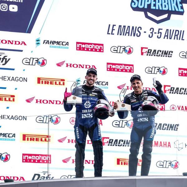 Zu sehen ist die Siegerehrung von zwei Rennfahrern.